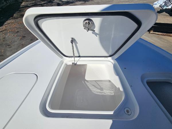 Open storage compartment on 2026 Sea Hunt BX 22 BR boat deck.