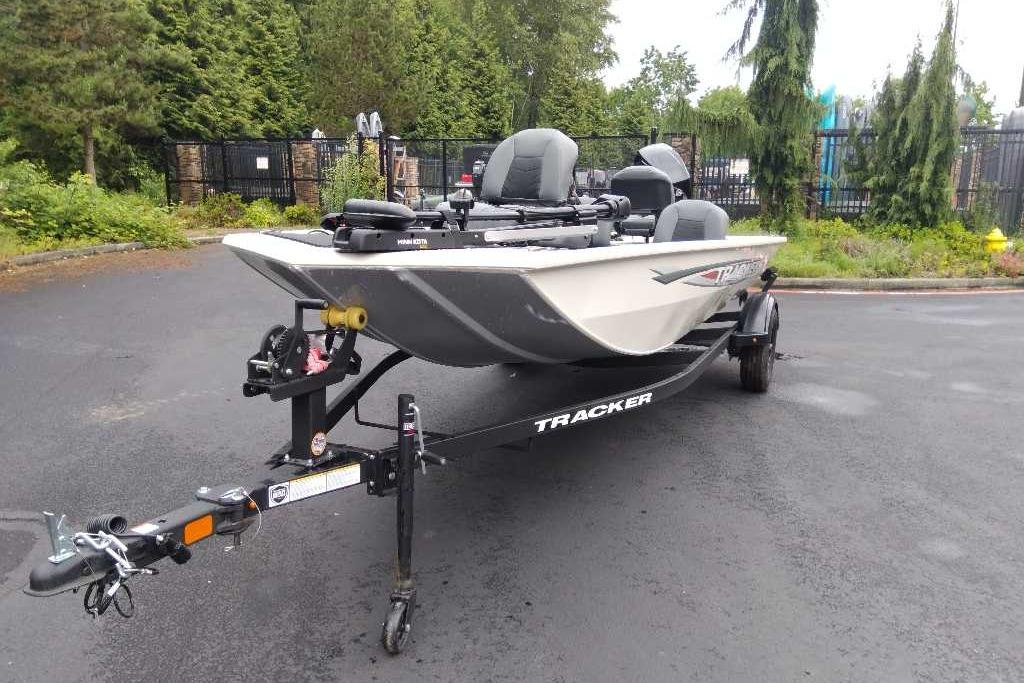 2026 Tracker Pro 170 boat on trailer, parked outdoors with lush greenery background.