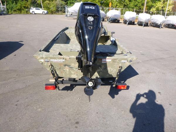 2024 Tracker Grizzly 1648 SC boat with outboard motor in a parking lot.