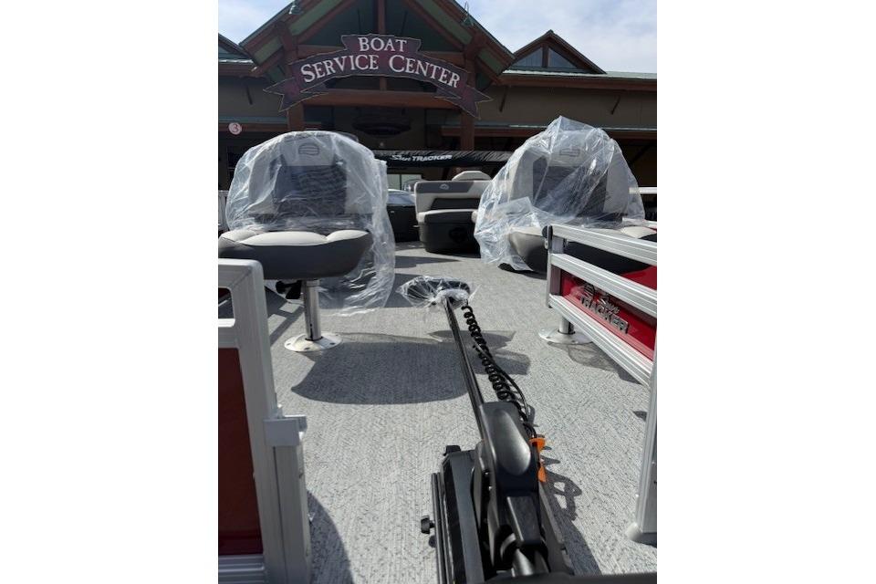 2026 Sun Tracker Bass Buggy 18 DLX at boat service center, seats covered in plastic.