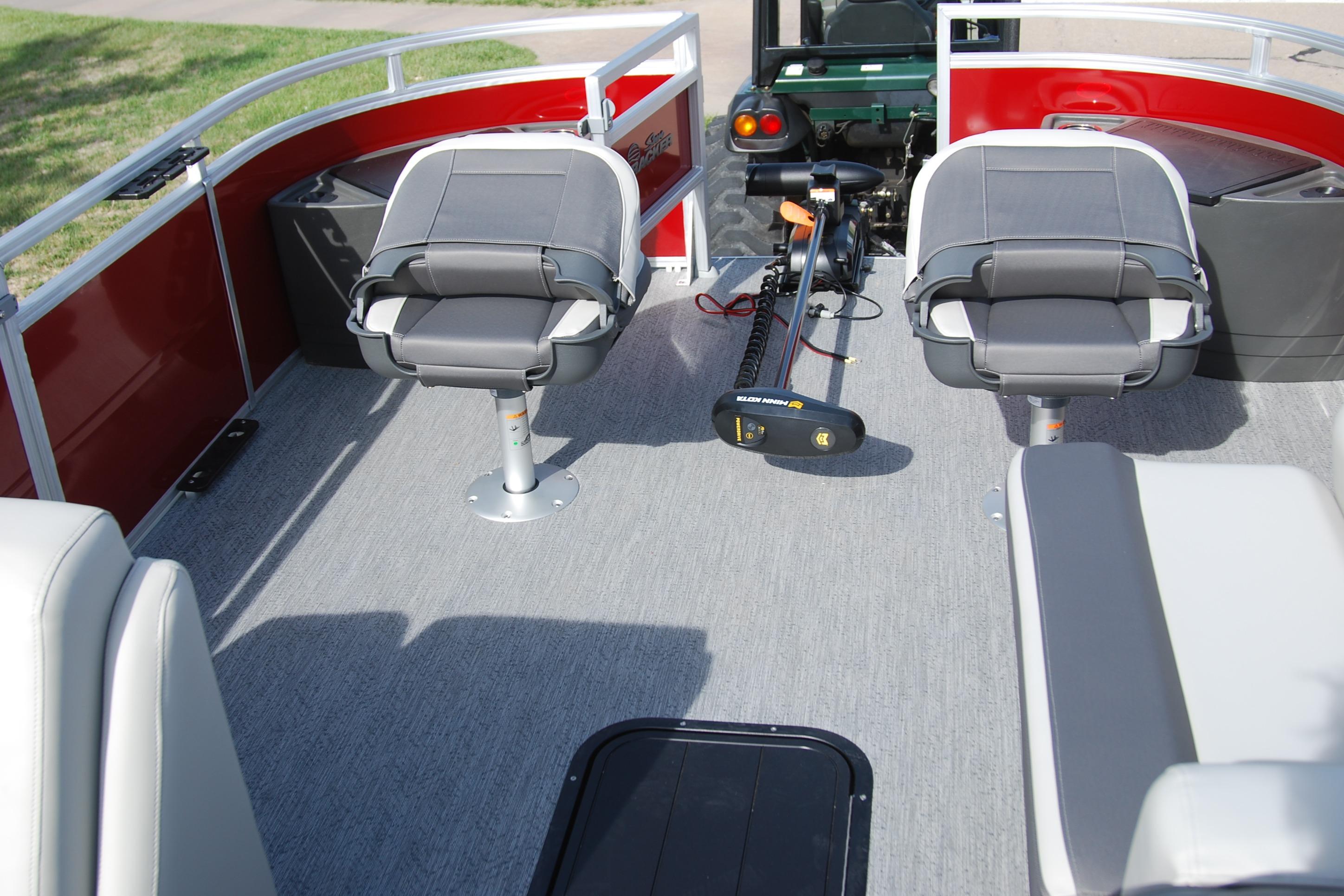 2026 Sun Tracker Fishin' Barge 22 XP3 interior with seating and fishing equipment.