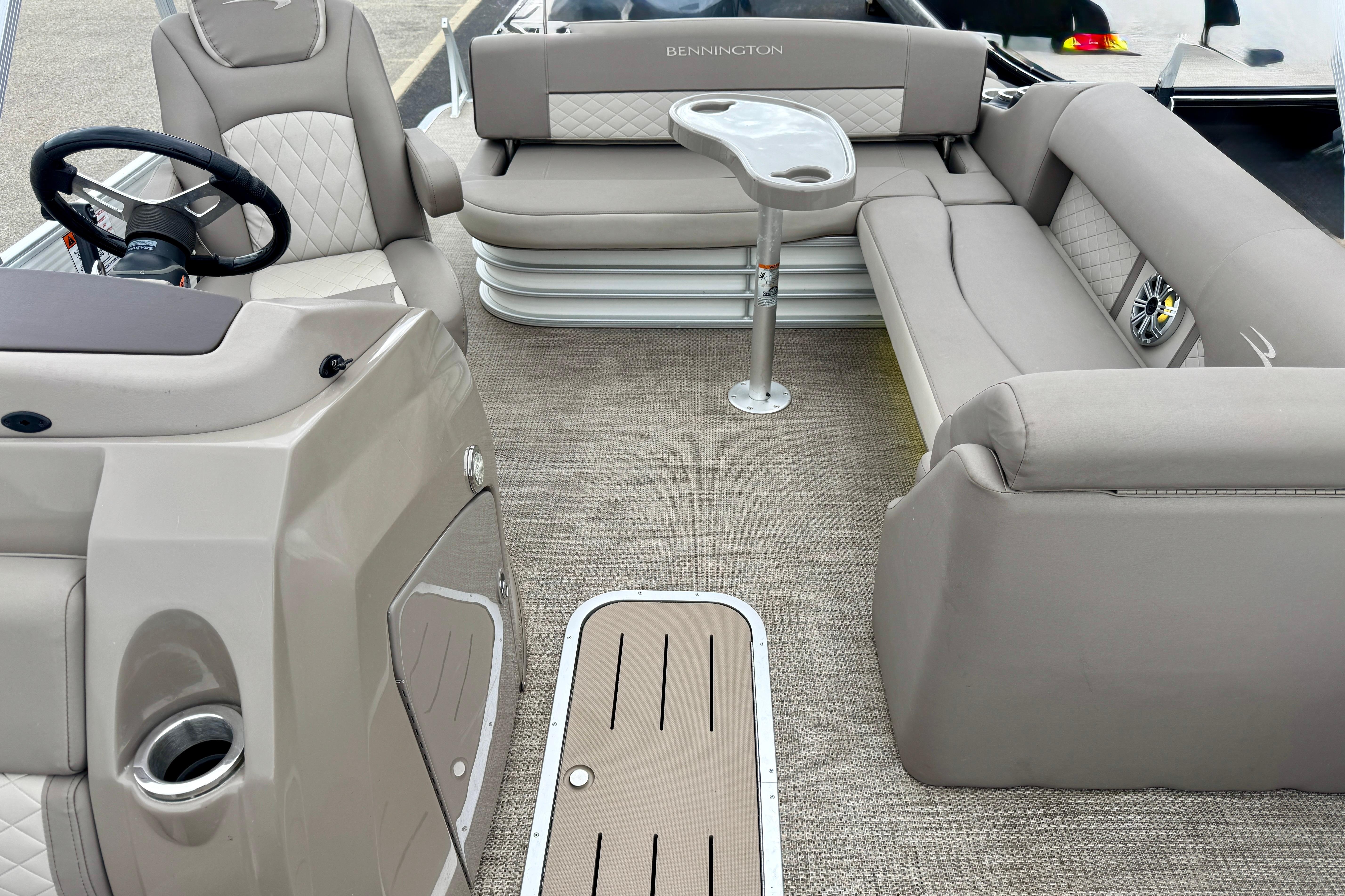 2019 Bennington SX 22 SSBXP pontoon boat interior with plush seating and steering console.