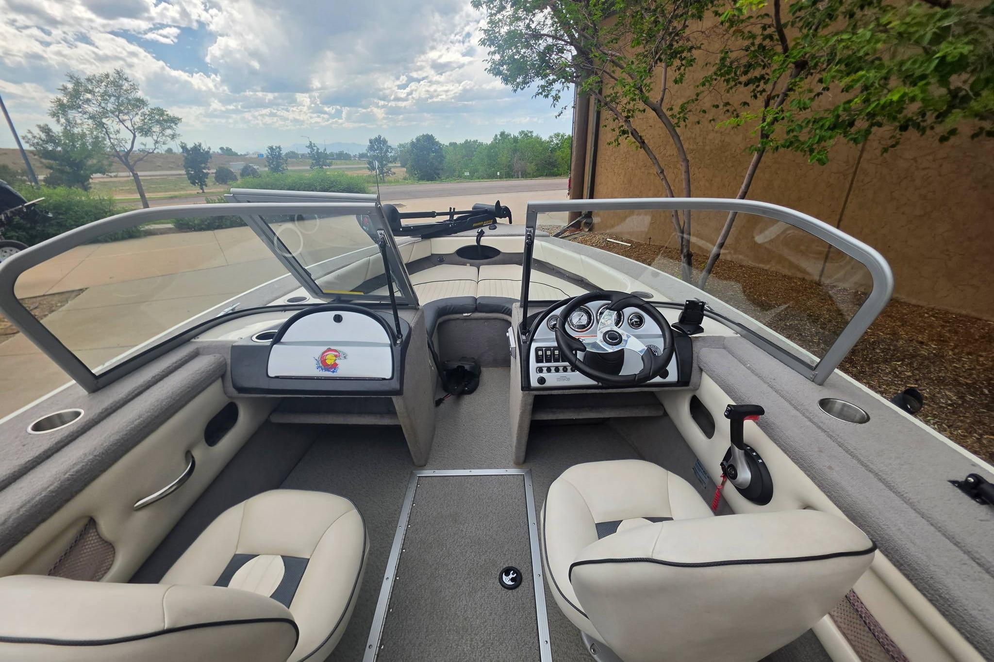 Interior of a 2010 Starcraft NexStar 1910 I/O boat with dual seating and steering console.