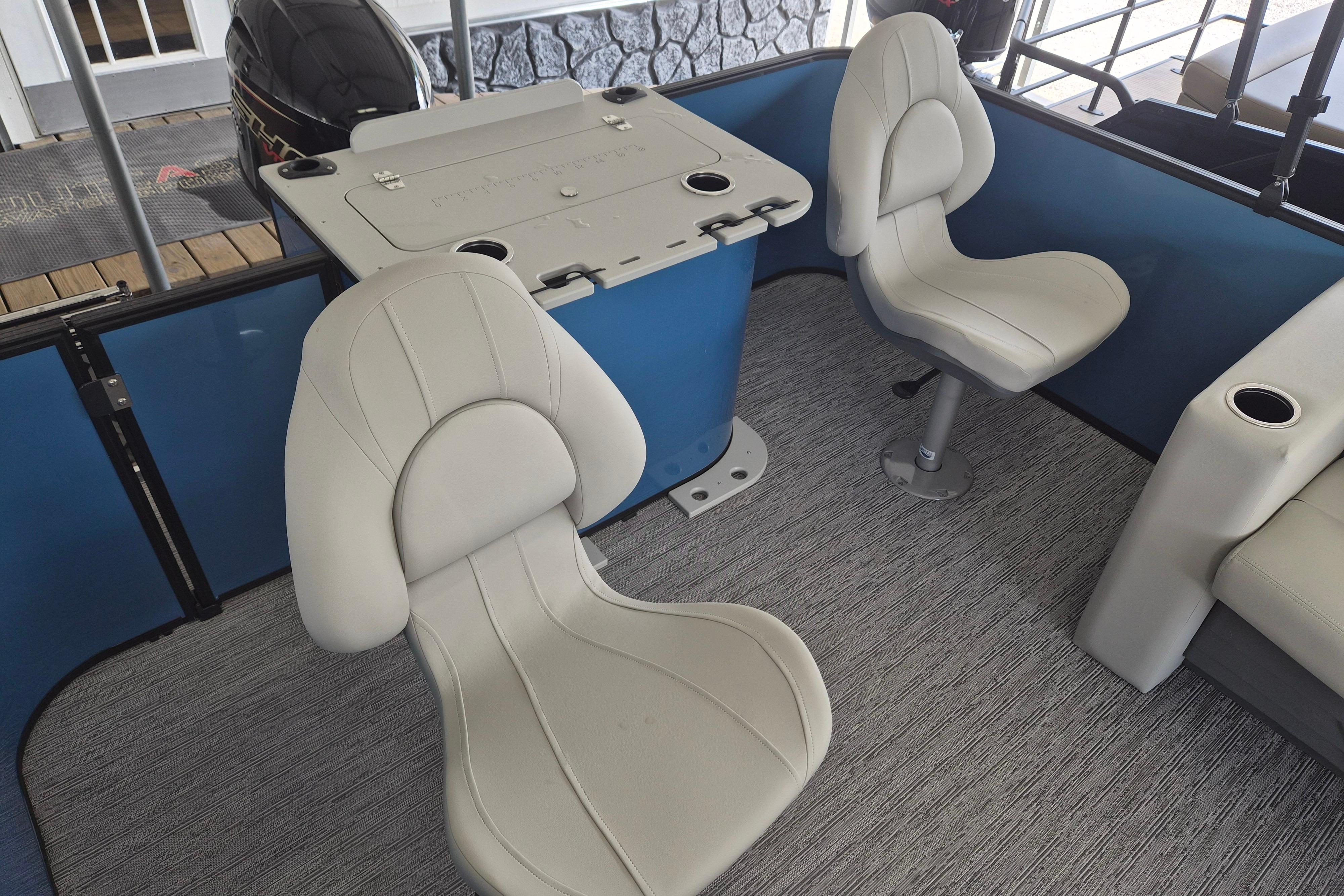 Interior of 2026 Sylvan Mirage Fish 820 Party Fish with swivel seats and fishing station.