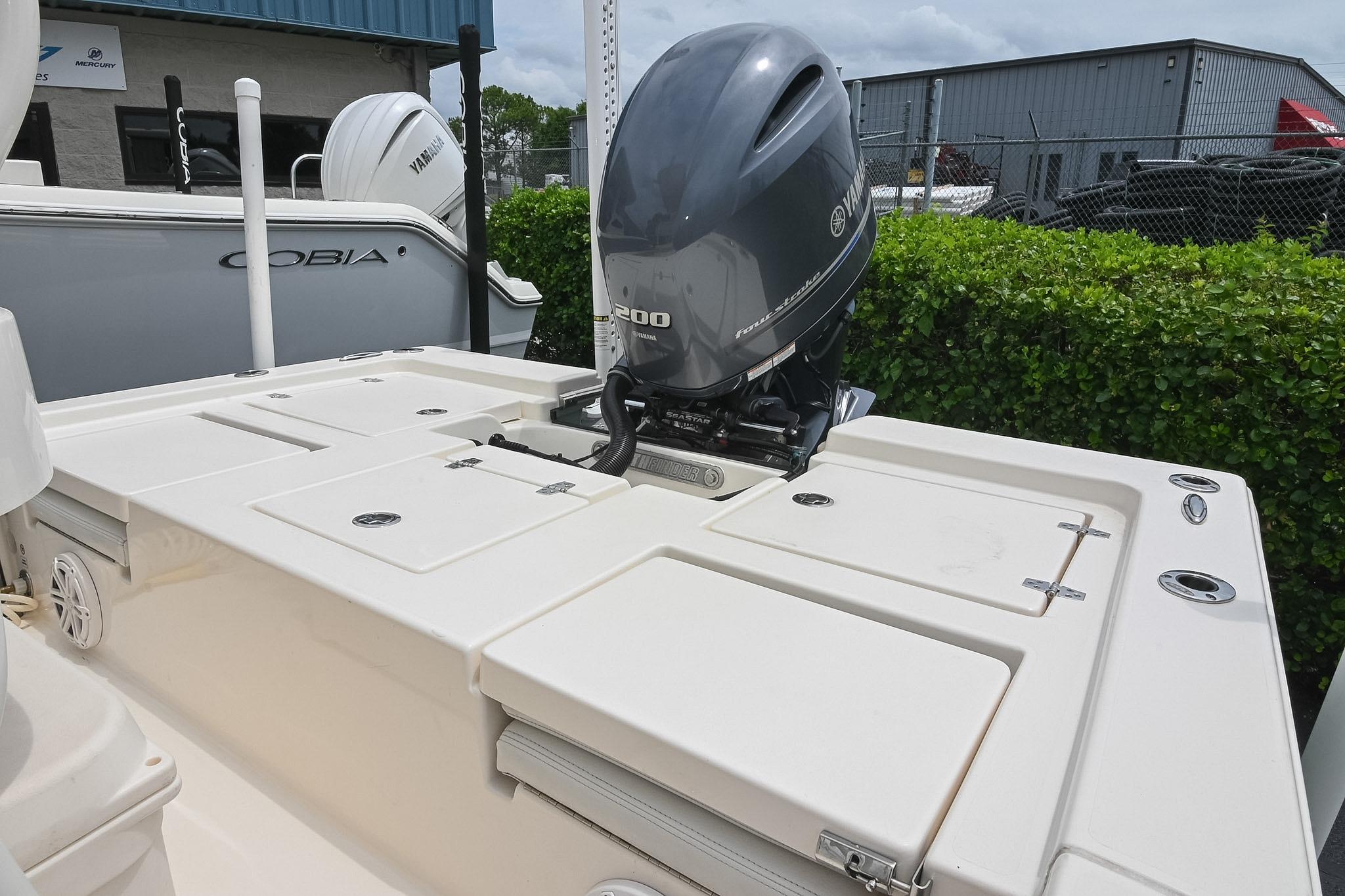 2021 Pathfinder 2200 TRS boat with Yamaha outboard motor, docked near other boats.