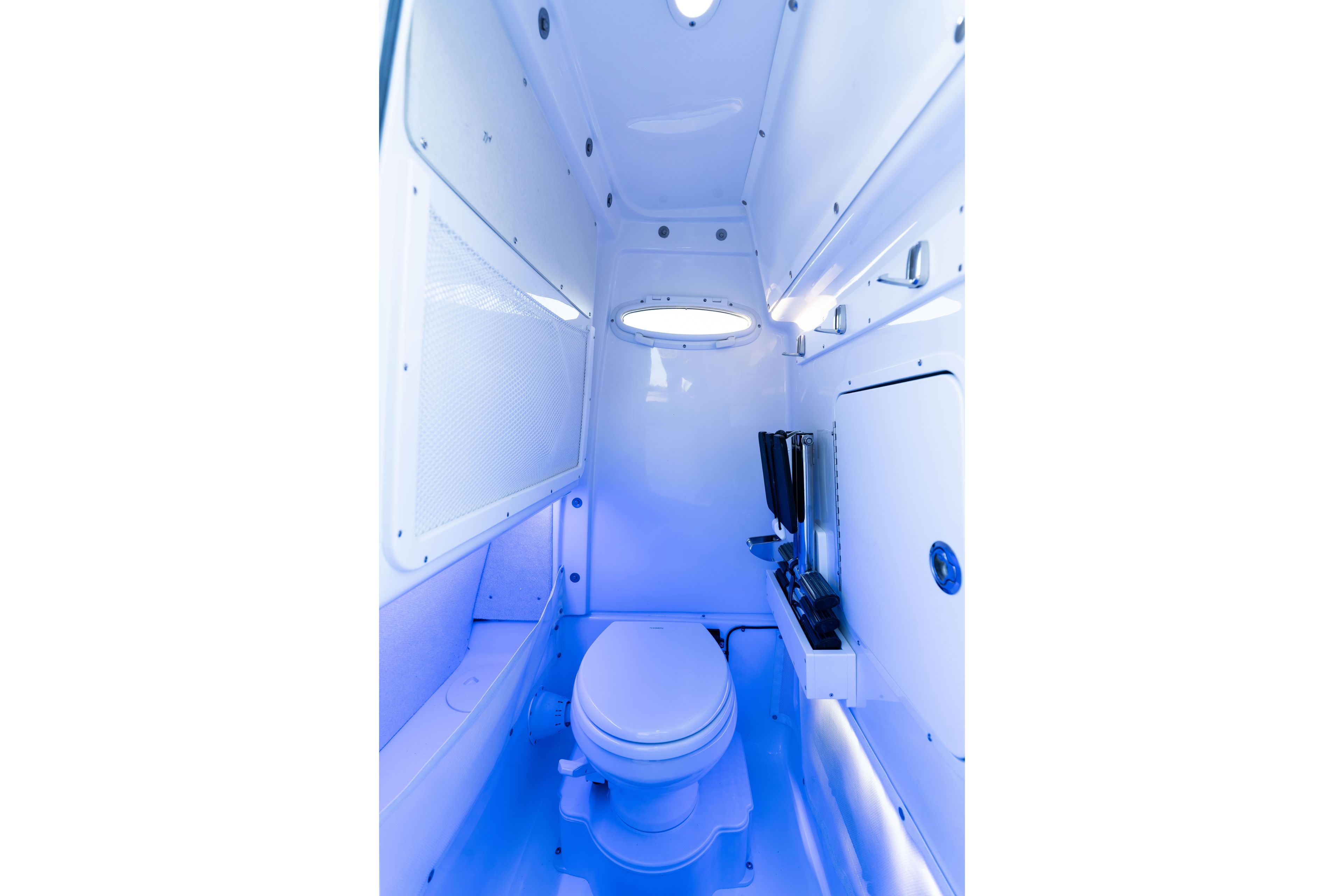 Interior of 2026 Sea Hunt Ultra 275 Coffin Box boat, featuring a compact marine toilet.