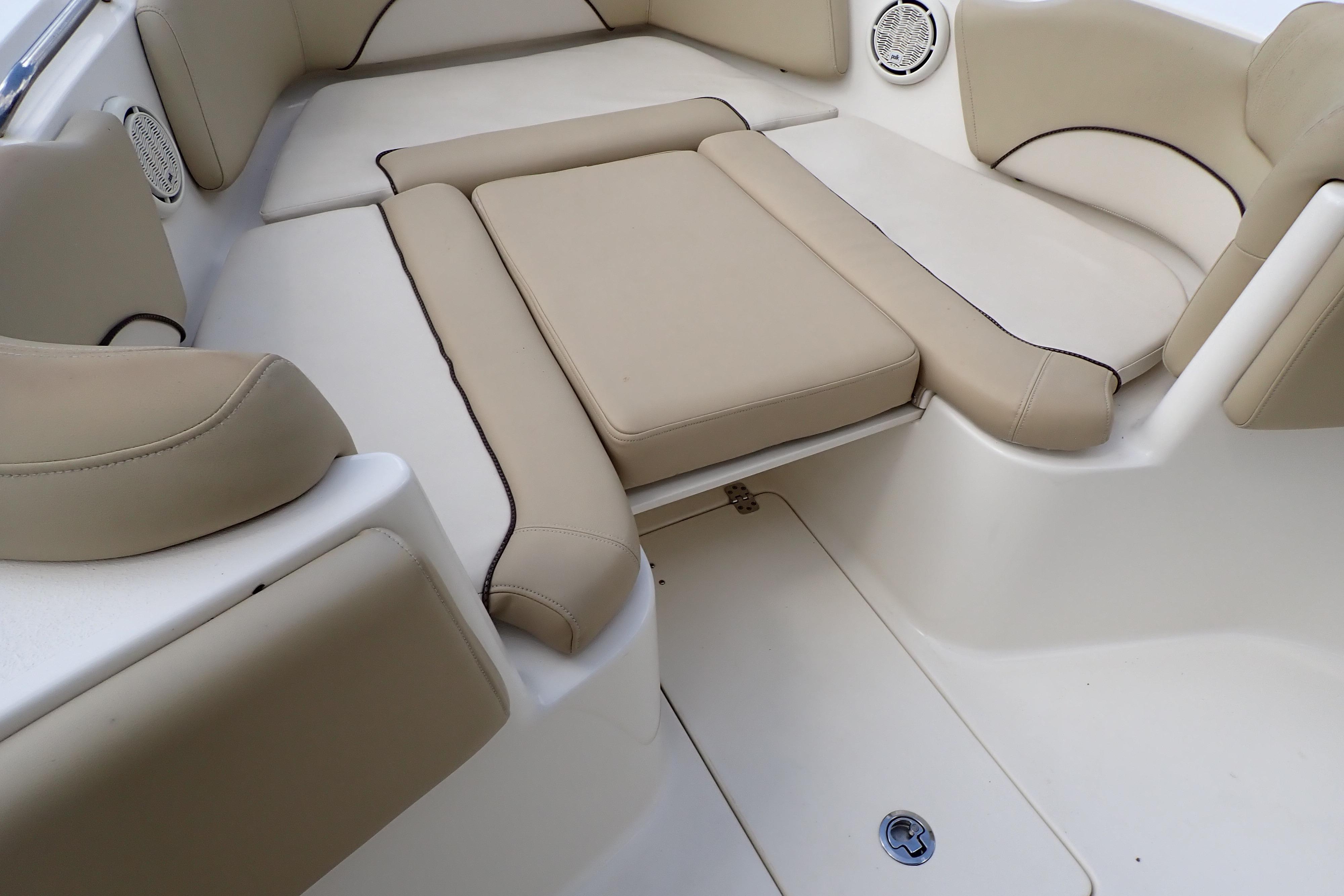 2019 Key West 263 FS boat interior with beige cushioned seating and speaker.
