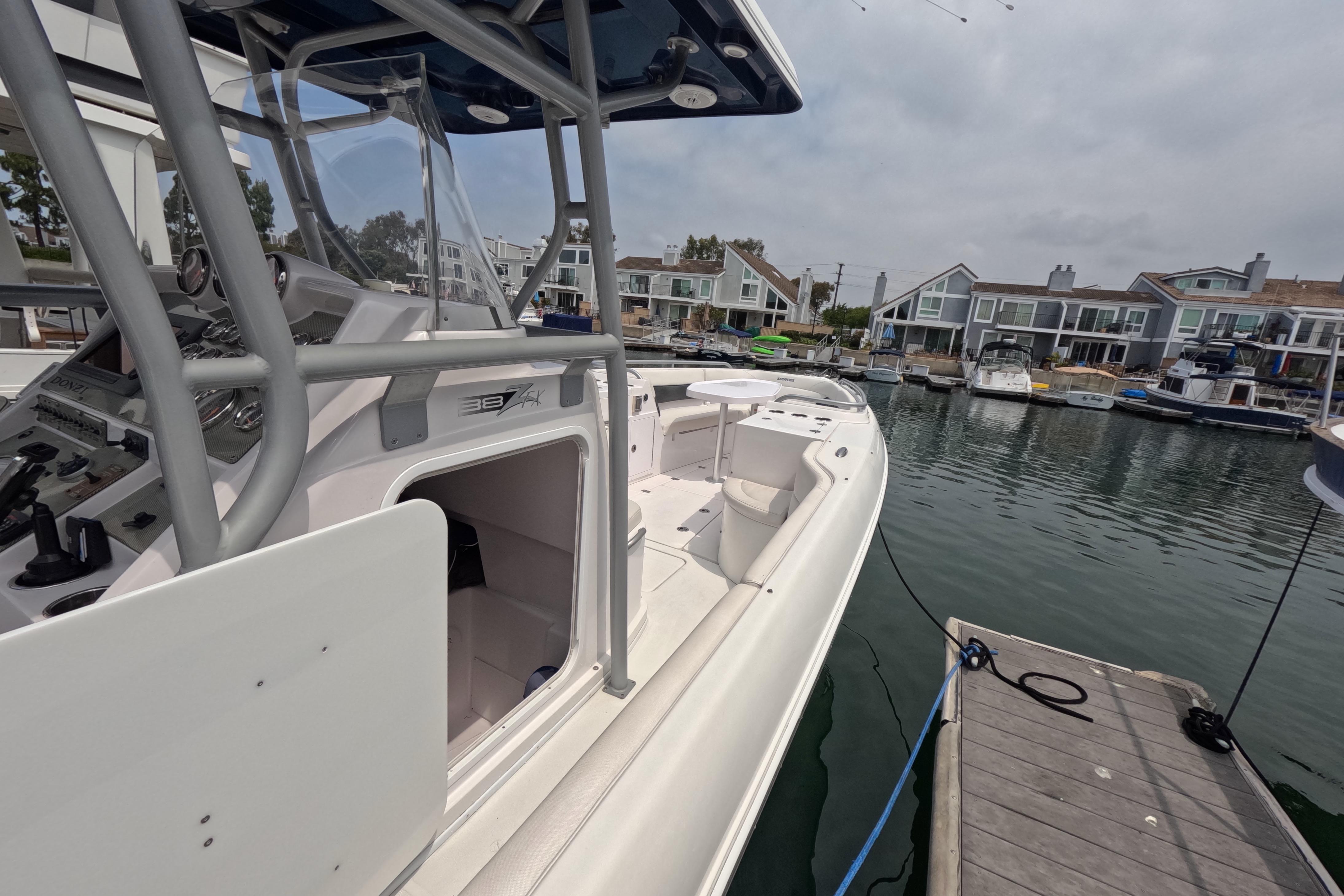 2011 Donzi 38 ZFX Open boat docked in a marina, showcasing sleek design and controls.