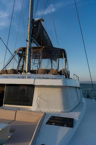2021 Bali 4.8 catamaran sailing on open sea at sunset.