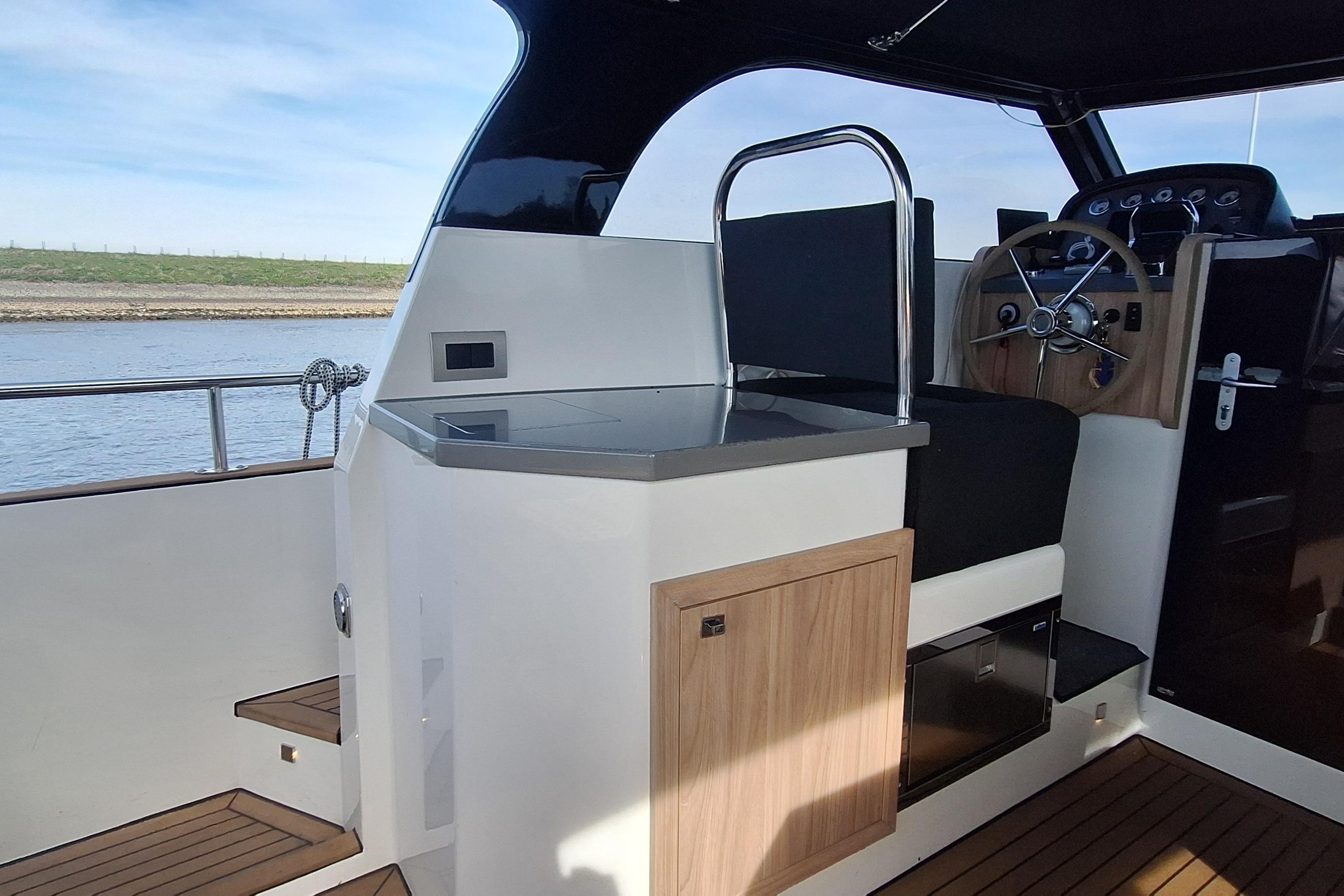 Interior of 2023 Antaris X boat with steering wheel and modern controls.