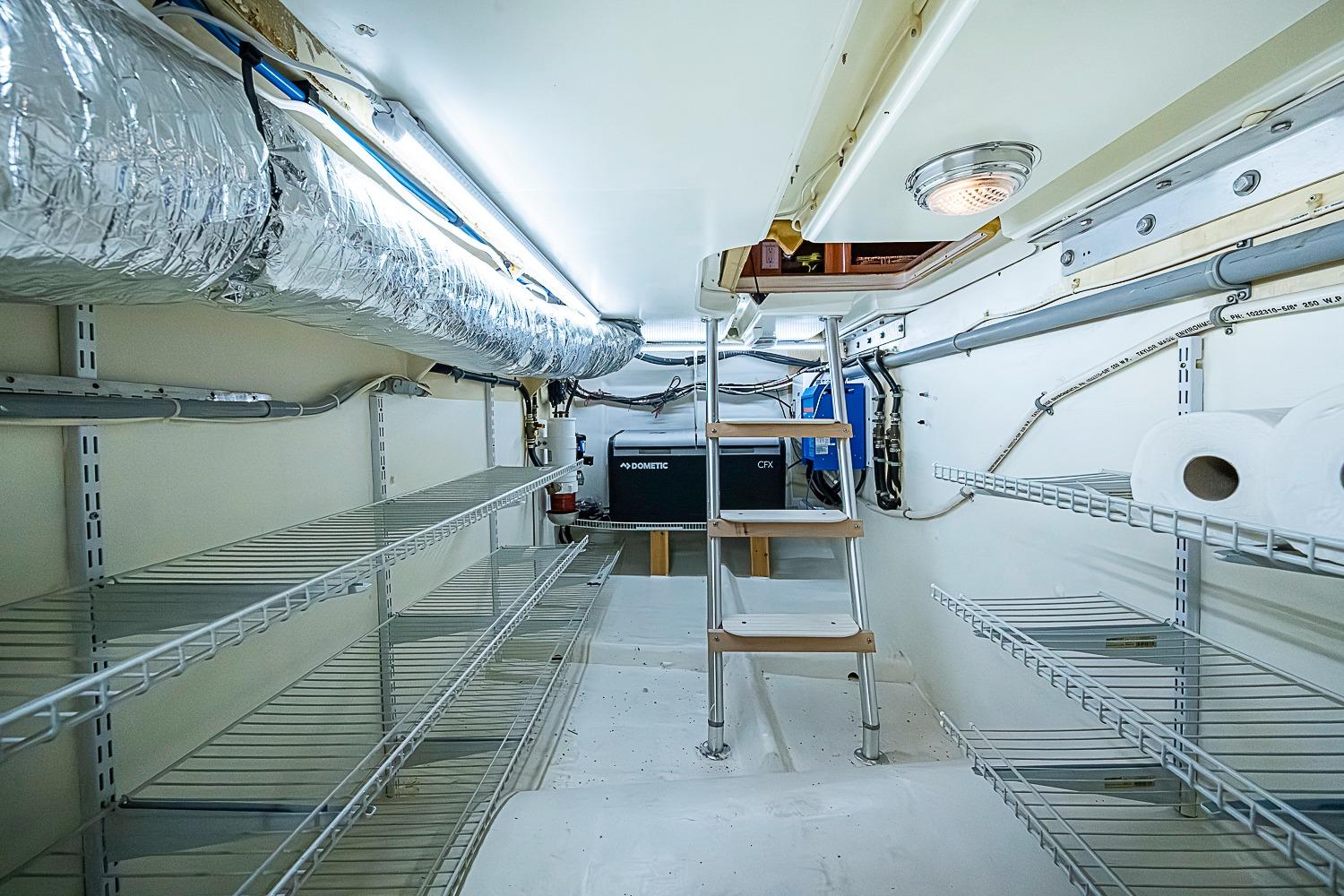 Engine room of 2003 Magna Marine Nova Scotia 47 with shelves and ventilation ducts.