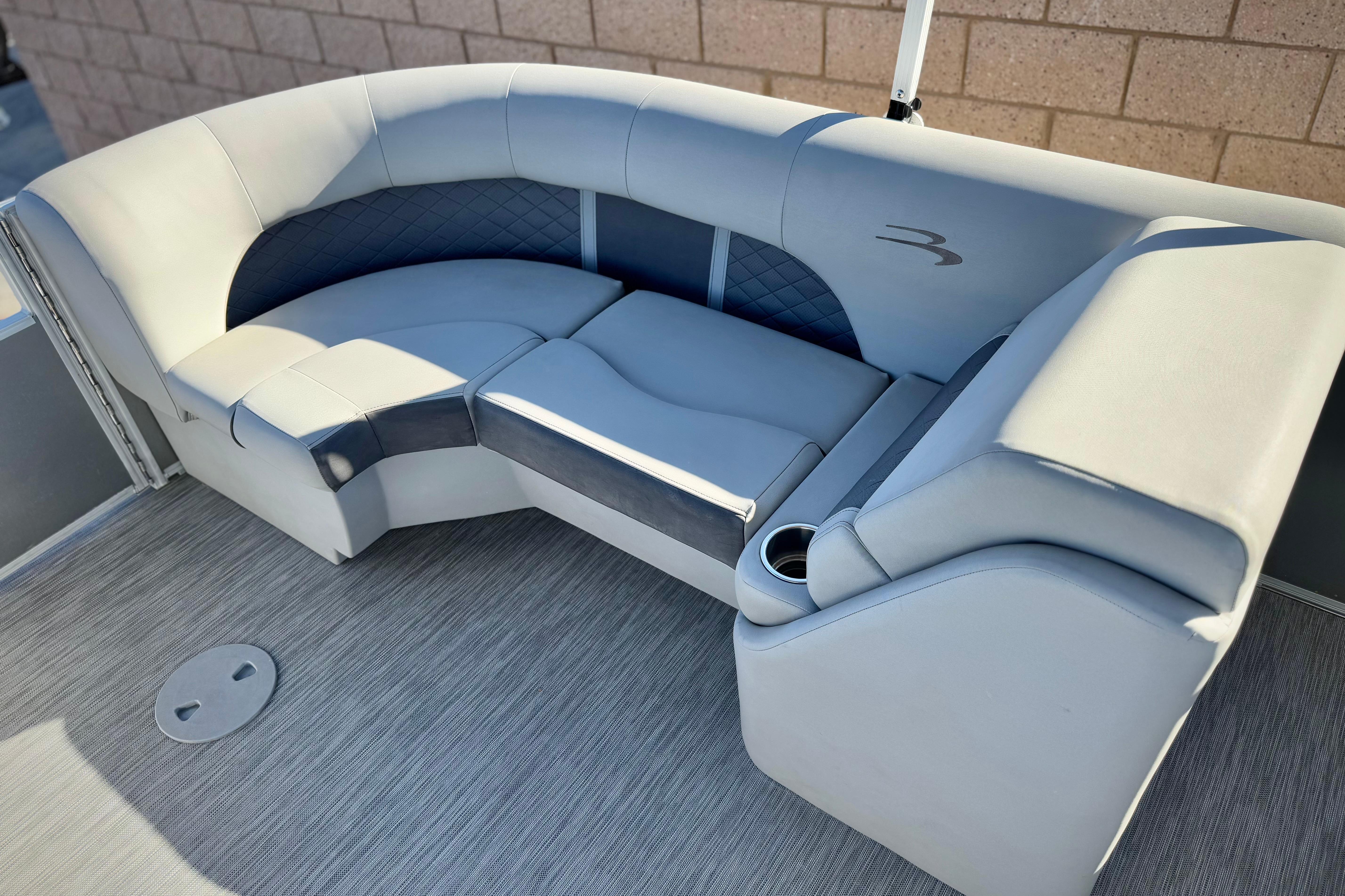 2021 Bennington 23LSR boat interior with plush gray seating and cup holder.
