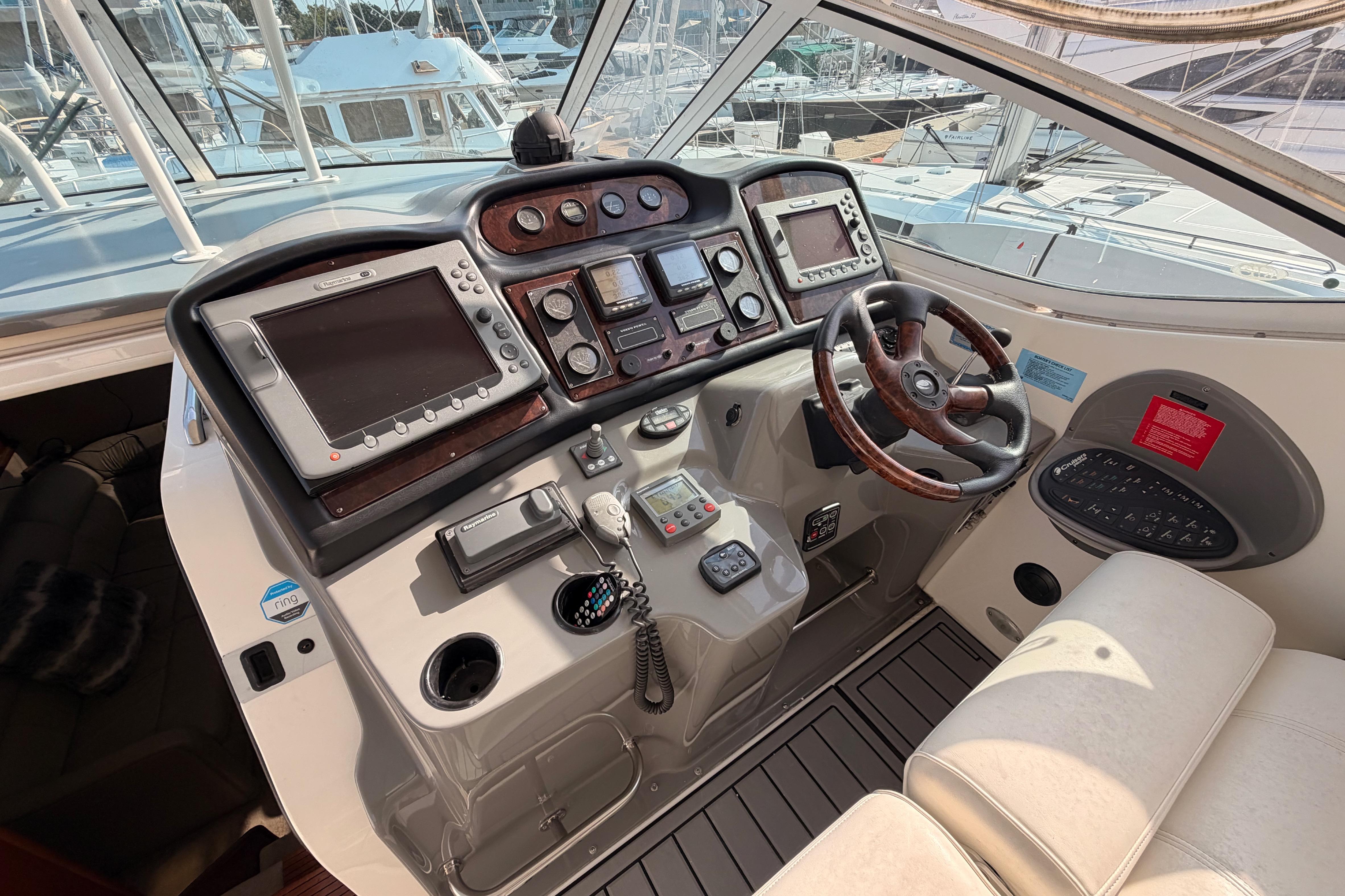 Helm of 2005 Cruisers Yachts 405 Express Motoryacht with navigation equipment and steering wheel.