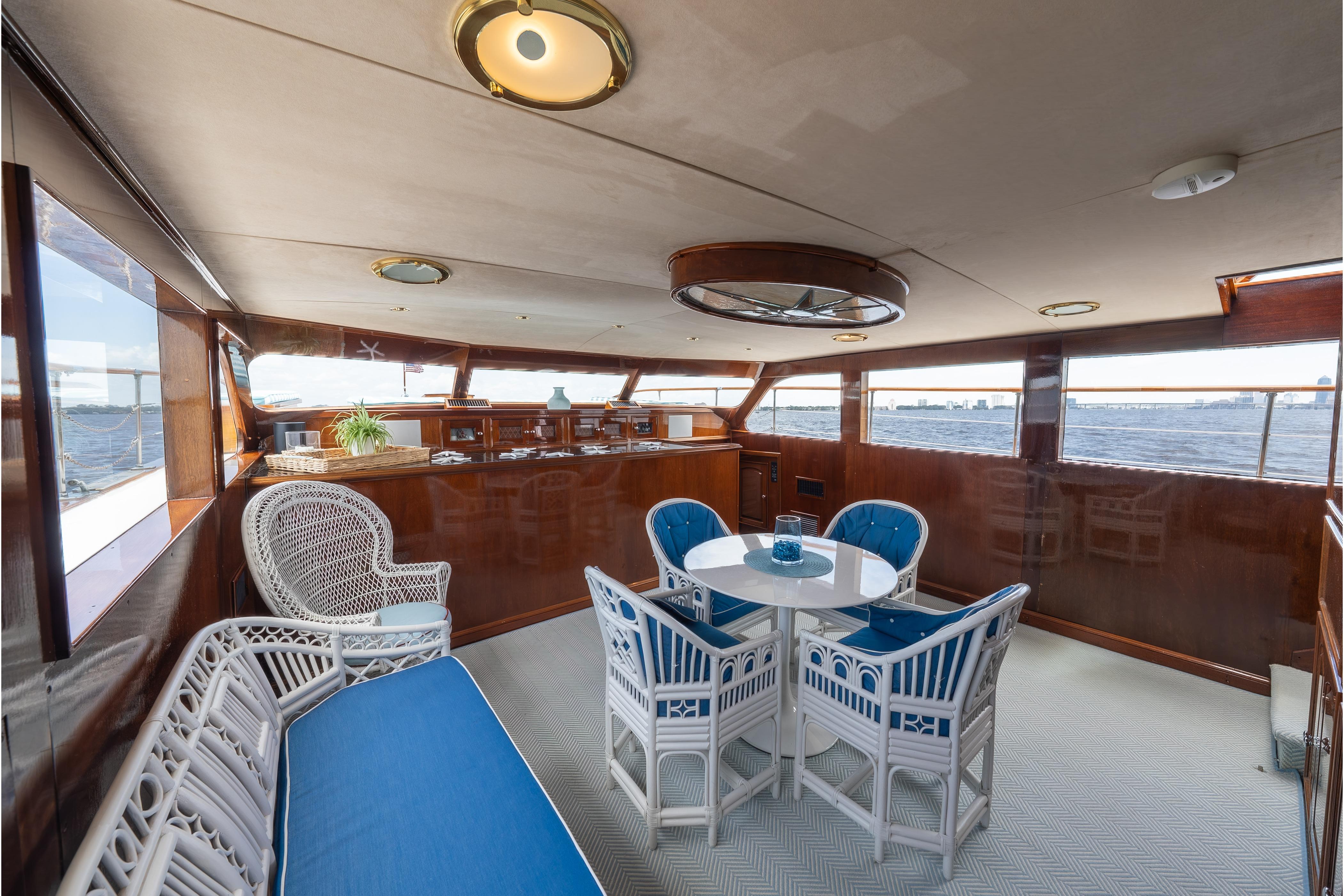 Luxurious 1963 Trumpy Classic yacht interior with elegant seating and panoramic ocean views.