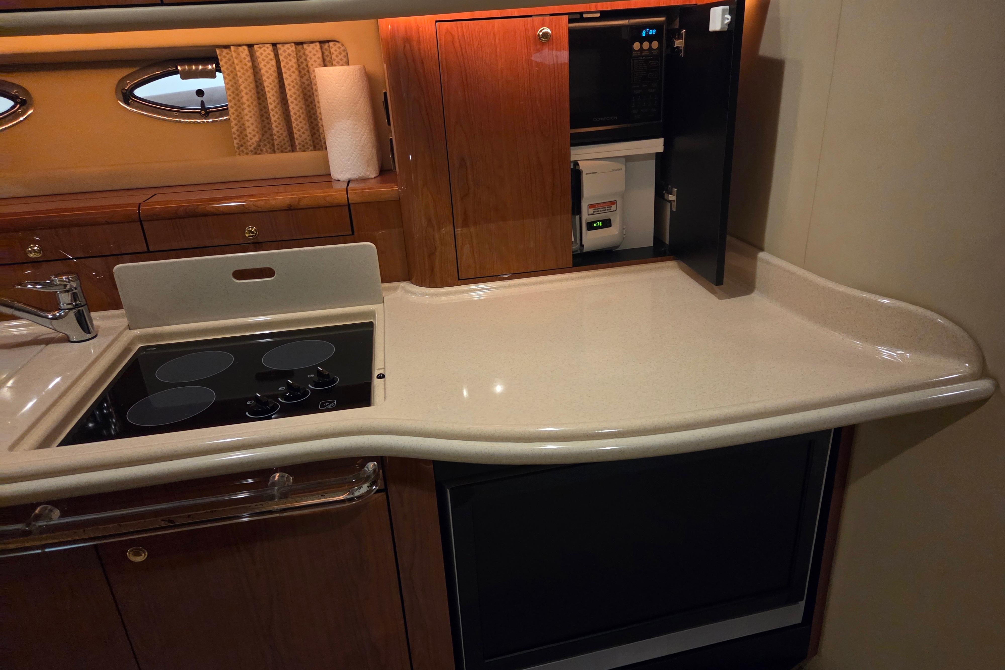 Kitchen area of a 2000 Sea Ray Sundancer 540 yacht with stove and countertop.