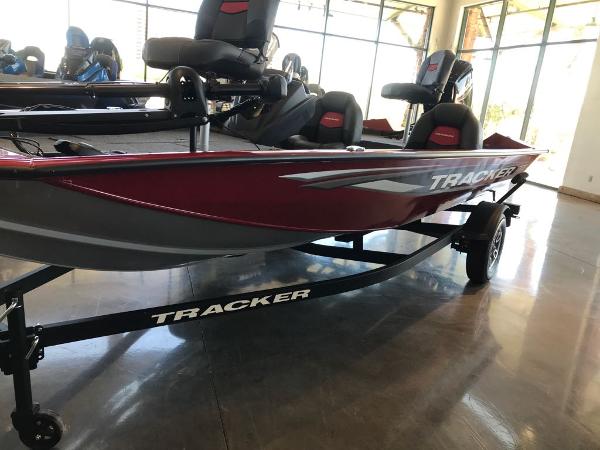 2025 Tracker Pro Team 175 boat in showroom, red and gray design, on trailer.