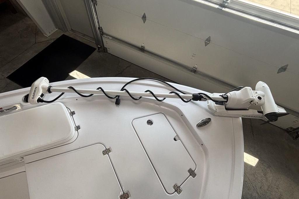 2026 Sportsman Masters 247 Bay Boat with Garmin trolling motor in a garage.