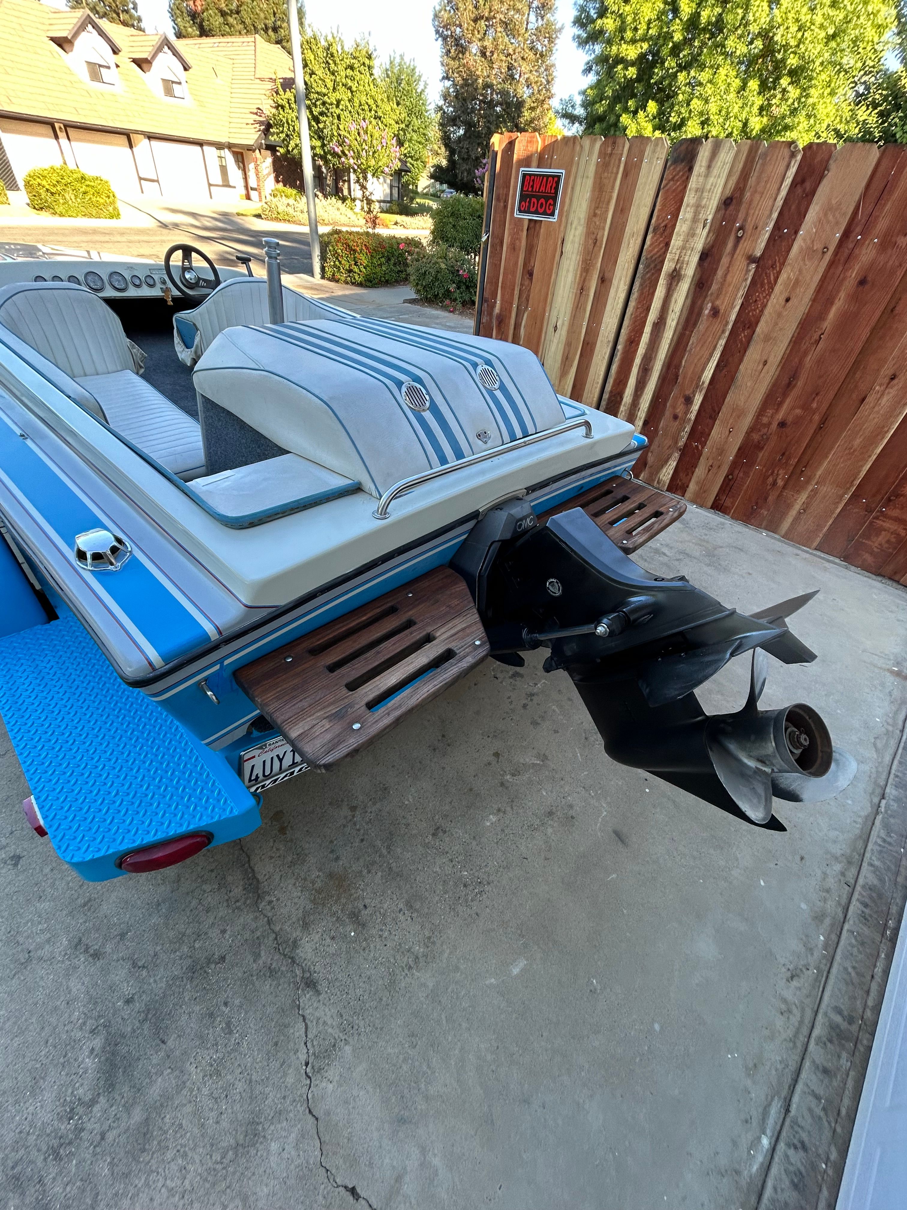 A 1988 Sanger Ski Tug with blue and gray striped design, parked on a driveway.