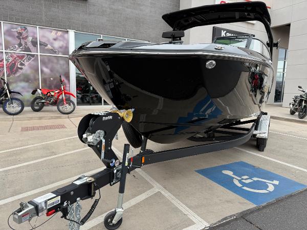 2025 Yamaha Boats 255XD on trailer in parking lot, near motorcycles.