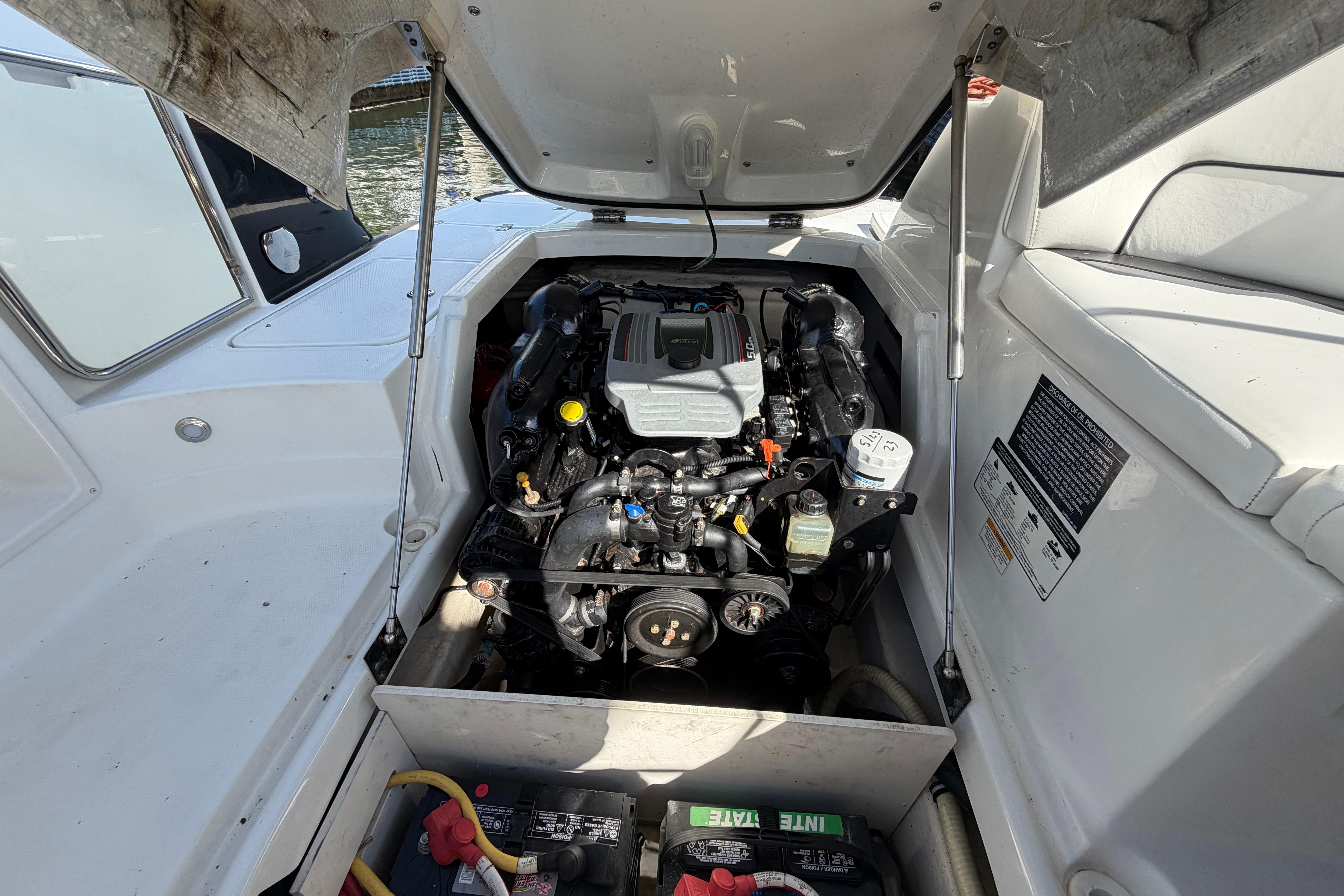 Engine compartment of a 2015 Monterey 264FS boat, showcasing detailed mechanical components.
