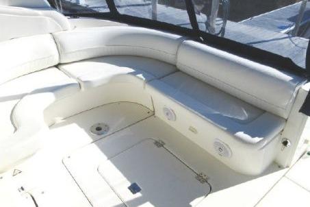 2005 Cruisers Yachts 370 Express interior with white seating and storage compartments.