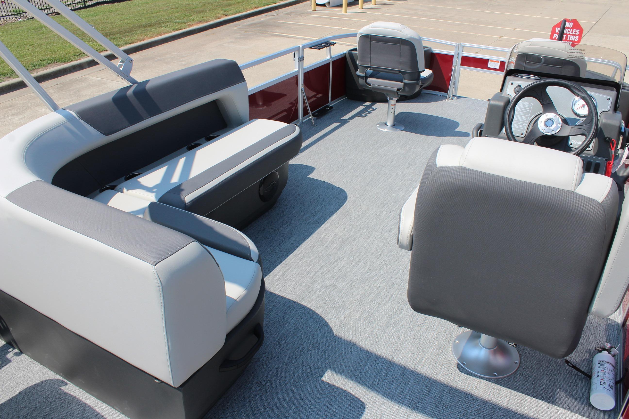 2026 Sun Tracker Bass Buggy 18 DLX pontoon boat interior with seating and steering console.