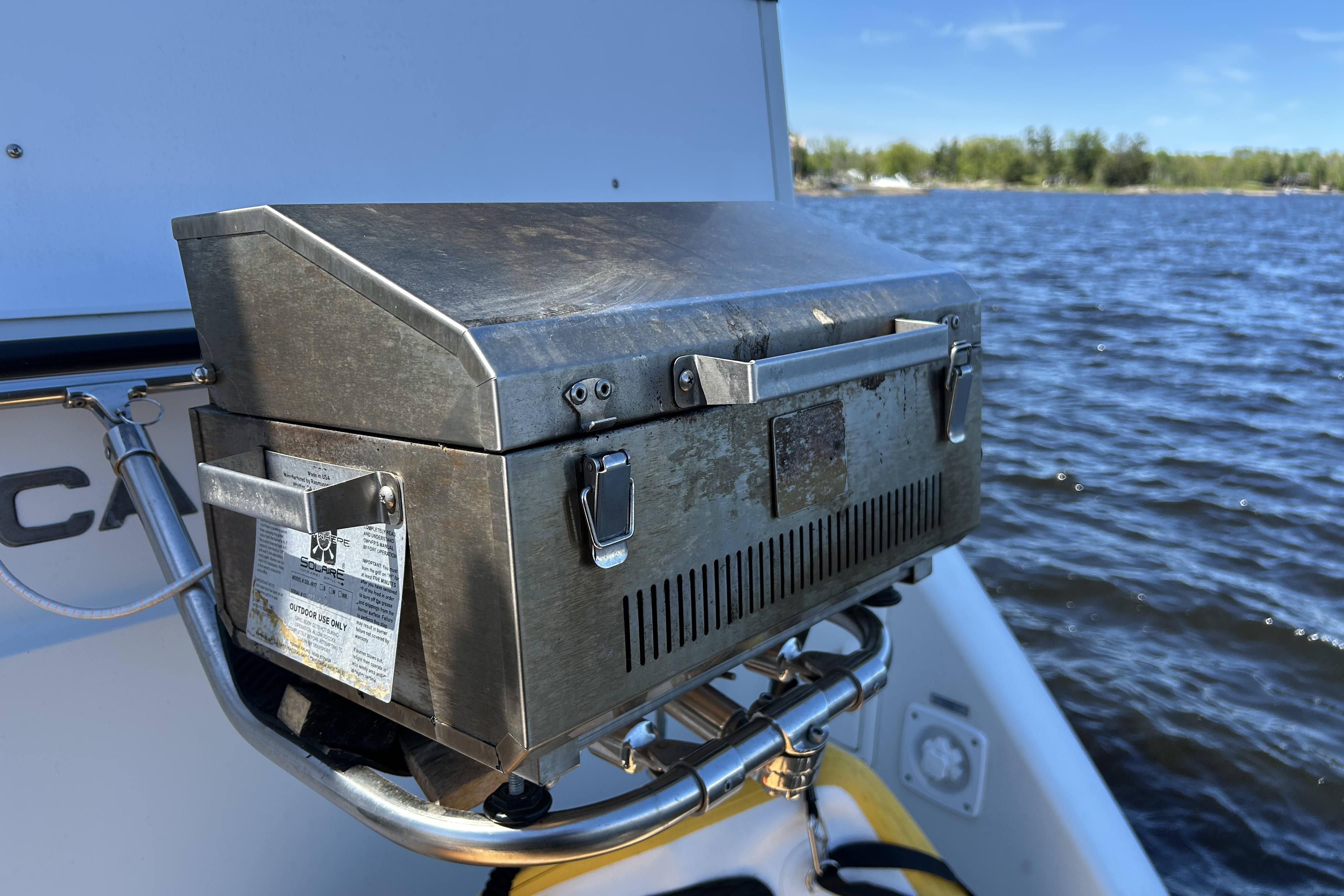 Stainless steel grill on 1995 Carver 355 Aft Cabin Motor Yacht by the water.