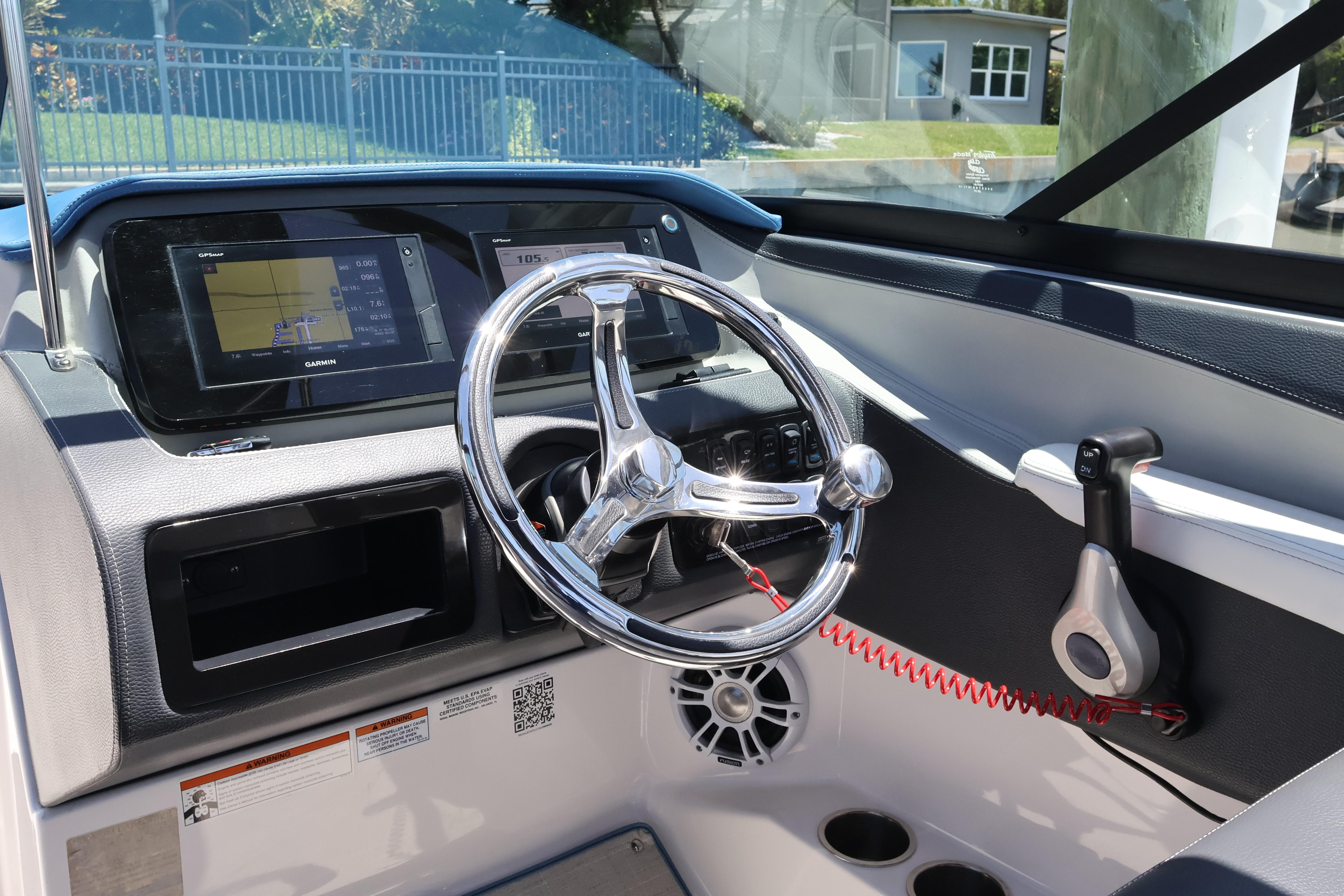 2020 Regal LX4 boat dashboard with steering wheel and Garmin GPS display.