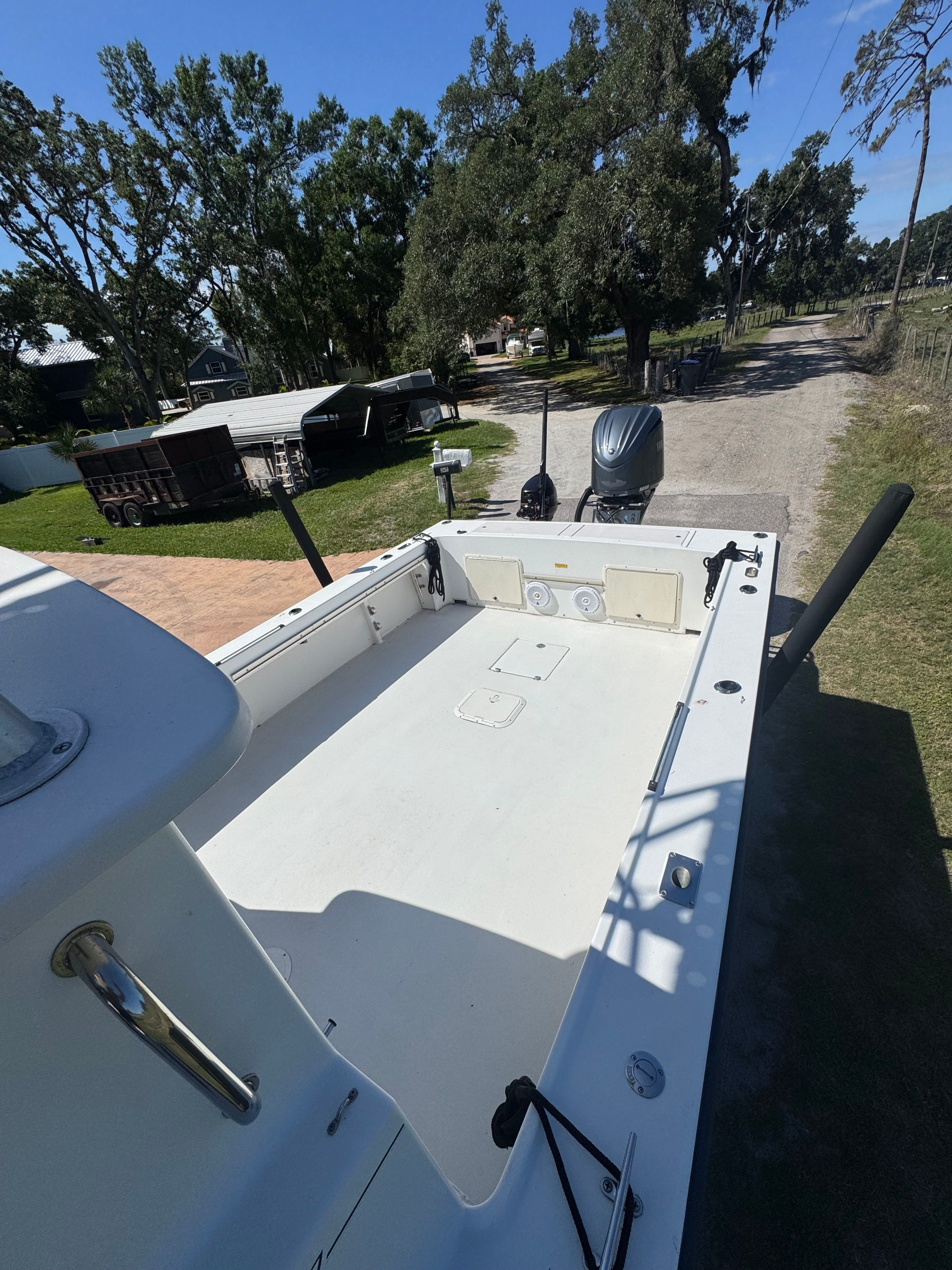 1997 Parker 2520 boat parked on a rural property.