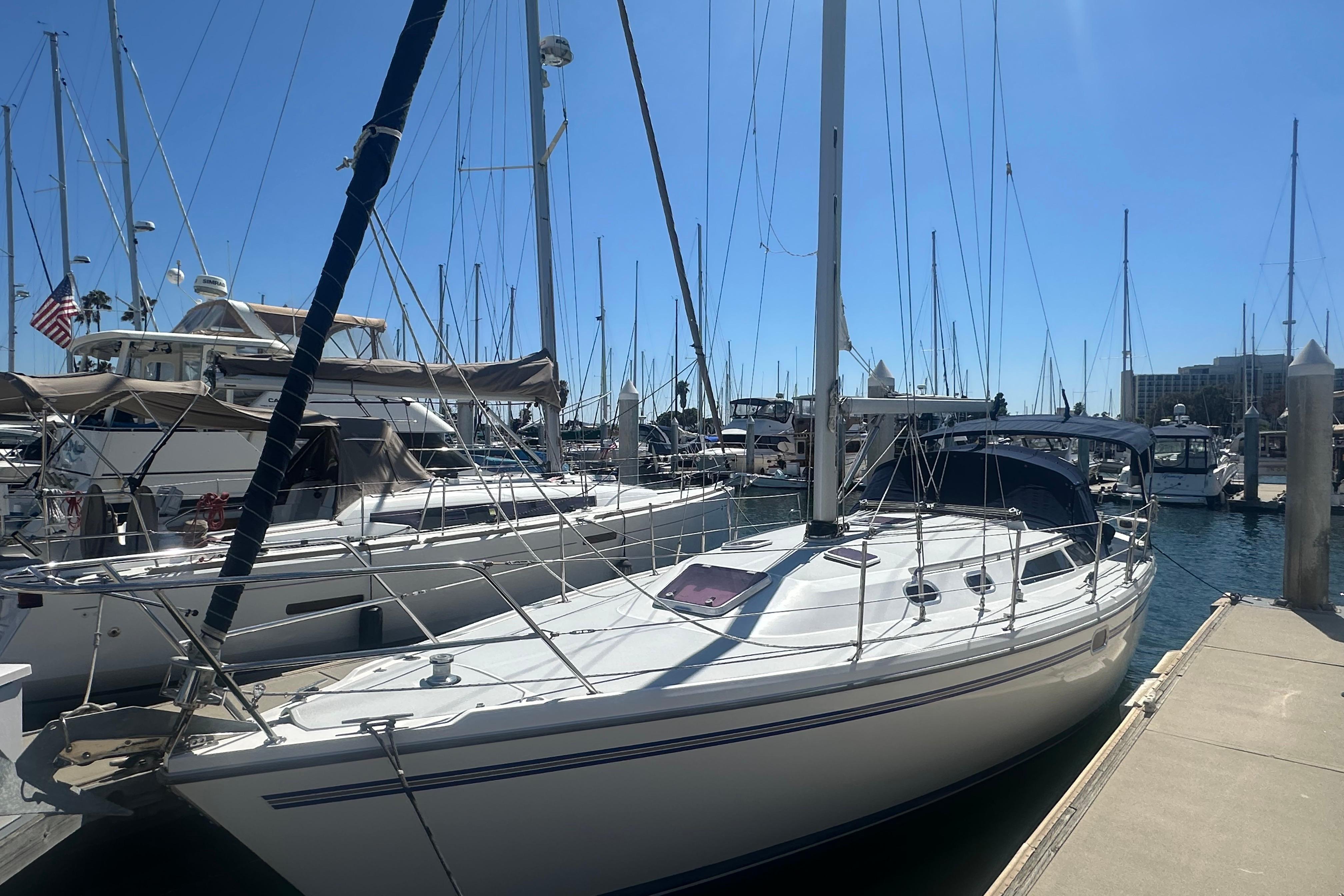 2005 Catalina 36 MkII sailboat docked at a marina under clear blue skies.