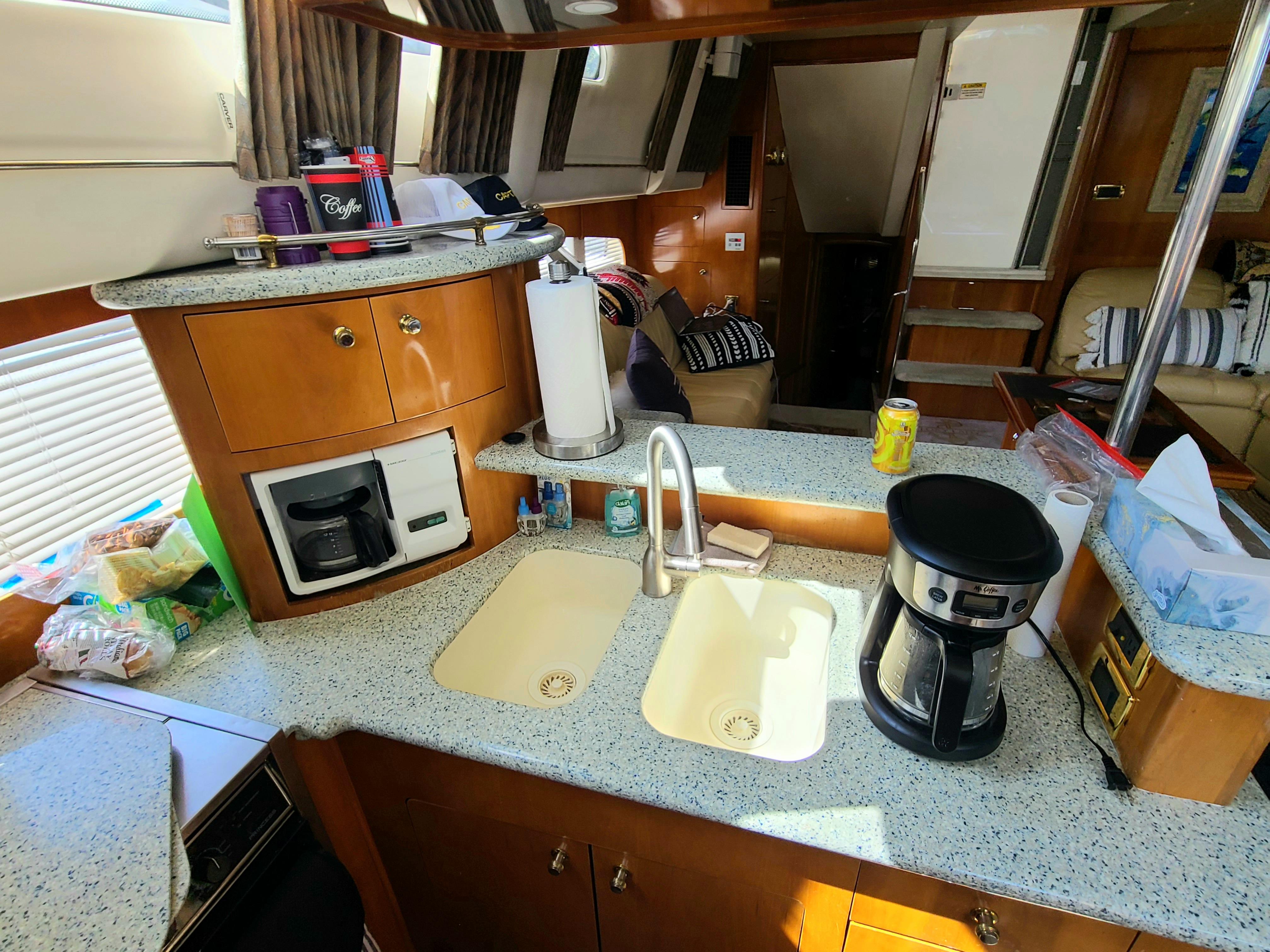 Interior of 2001 Carver 506 Motor Yacht kitchen with coffee maker and dual sinks.