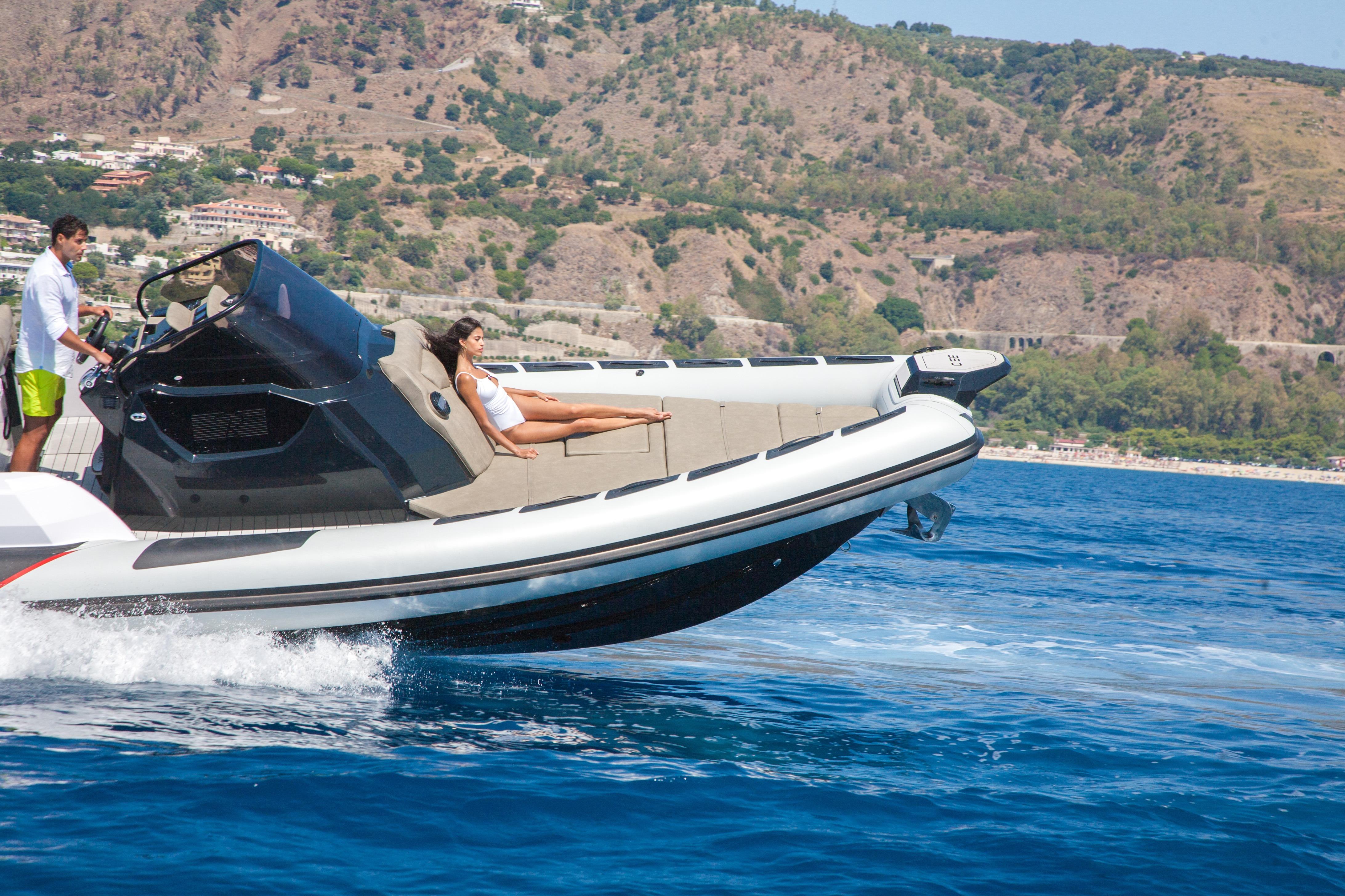 2026 Ranieri CAYMAN 35.0 EXECUTIVE cruising on blue water with scenic mountain backdrop.