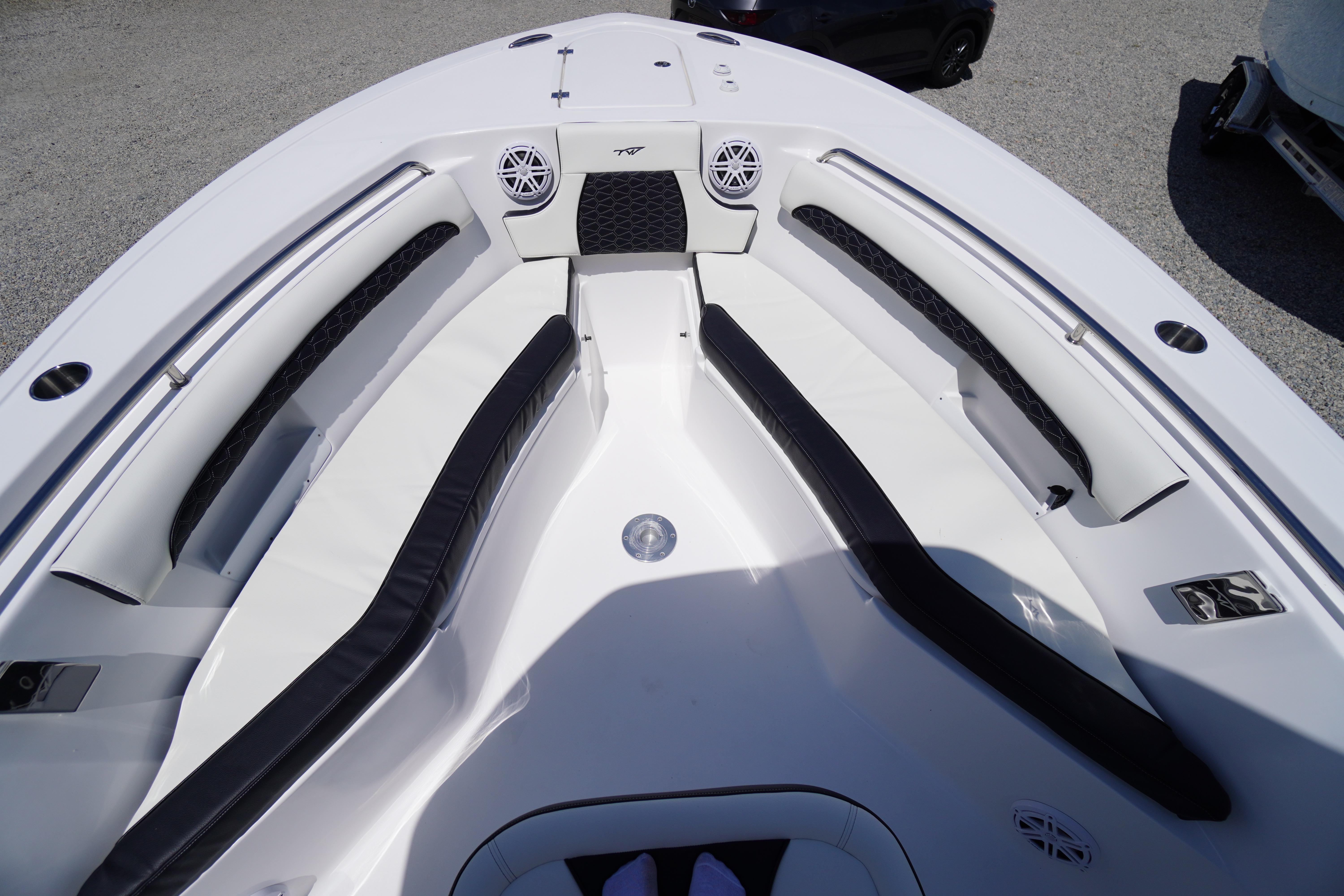 2026 Tidewater 232 LXF boat interior with cushioned seating and speakers.