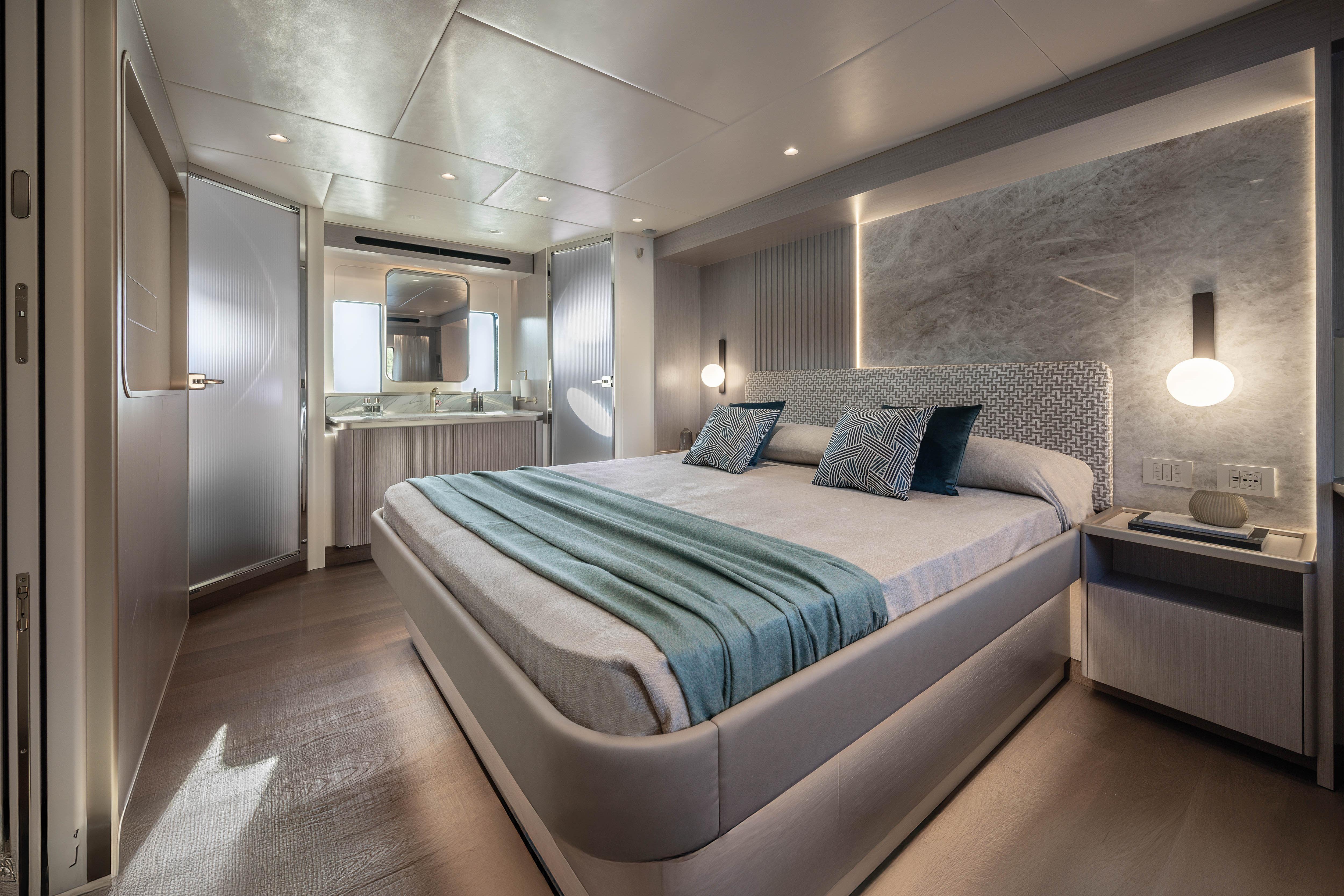 Luxurious bedroom on a yacht with modern design and elegant lighting.