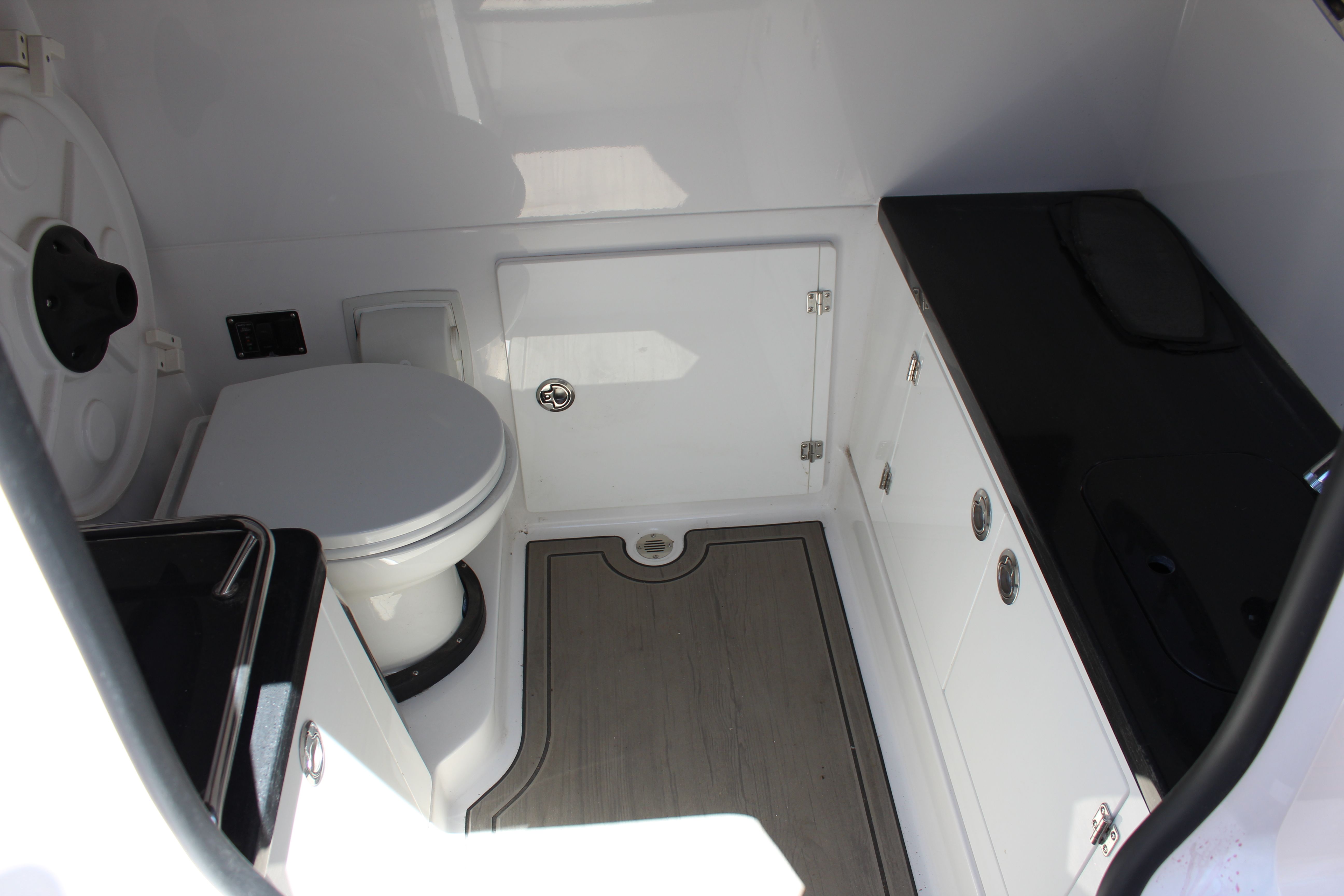 Interior of 2025 Monterey Elite 30 OB with toilet and storage.