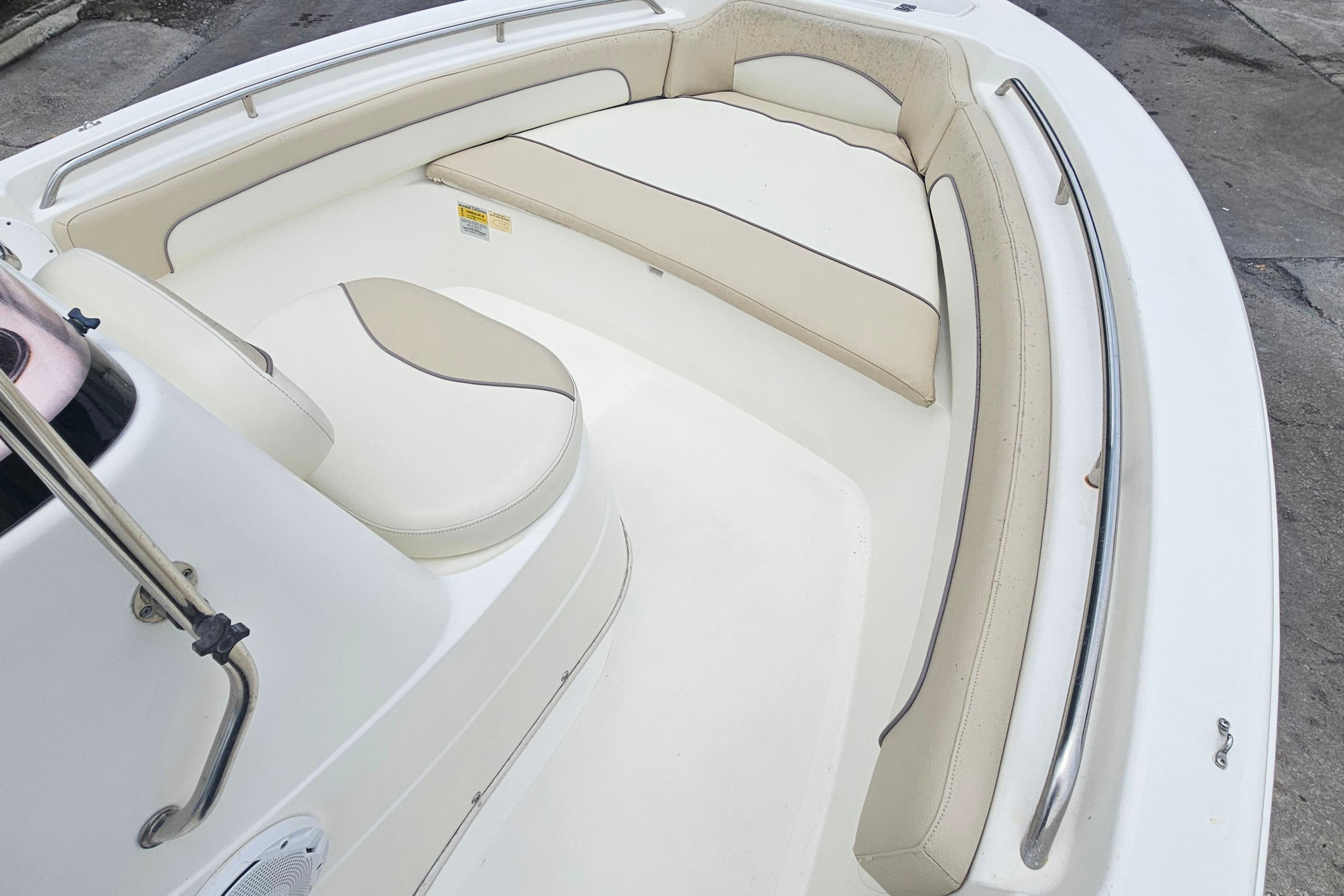 2018 NauticStar 19 XS boat interior with cushioned seating and stainless steel railings.