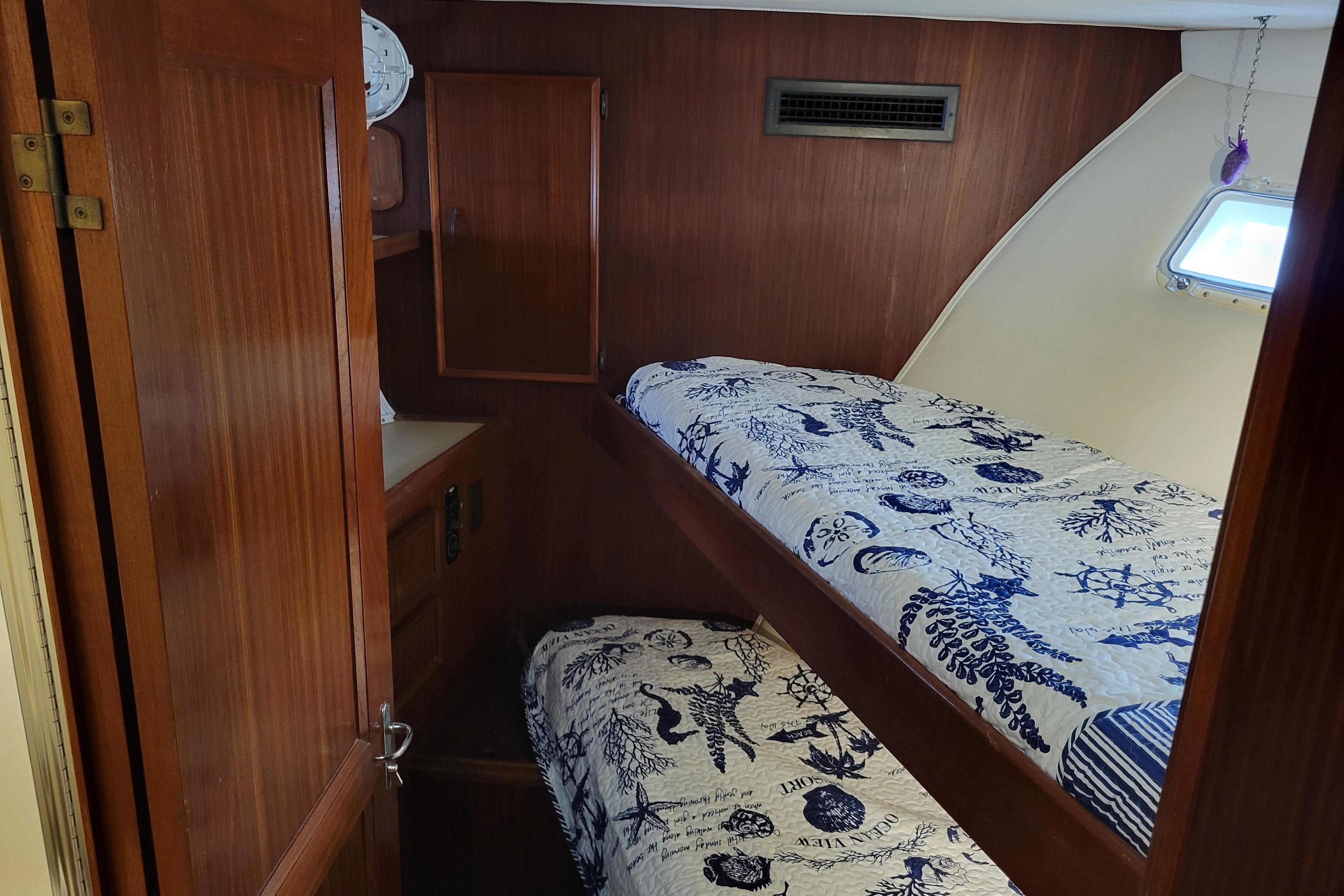 Interior cabin of 1980 Hatteras 53 Yacht Fisherman with wooden bunk beds.