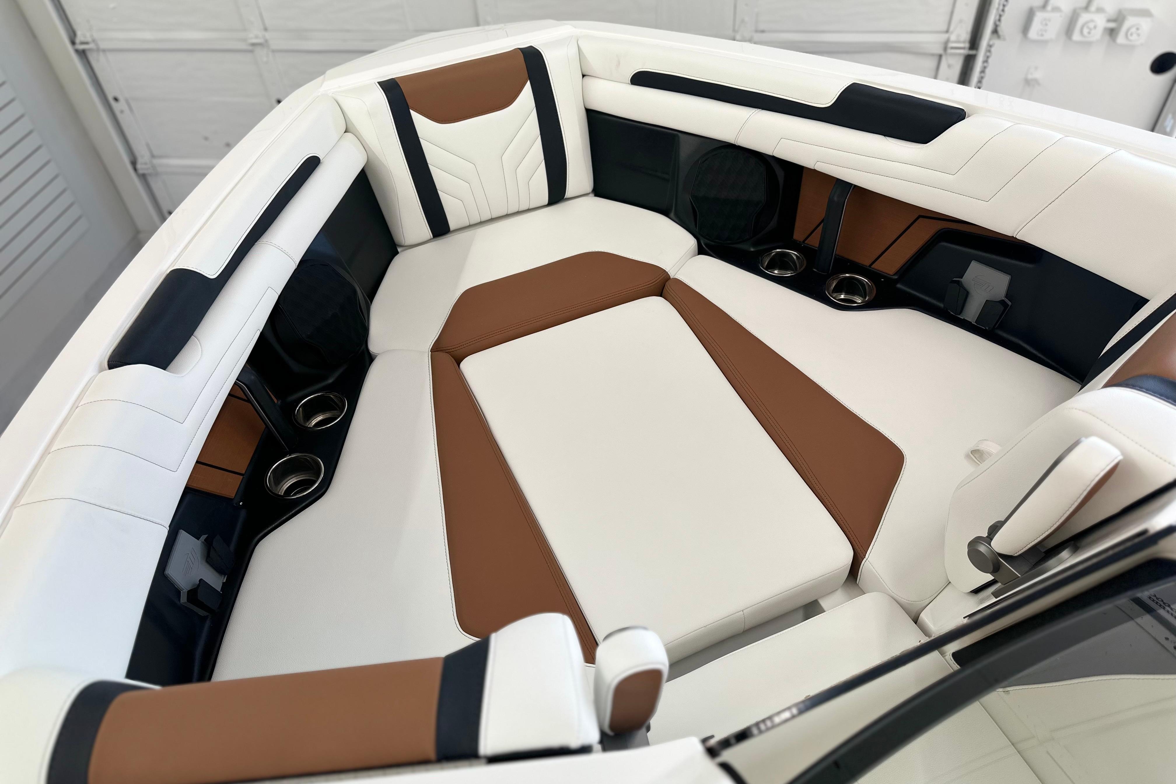 Luxurious interior of 2026 Malibu Wakesetter 25 LSV boat with brown and white seating.