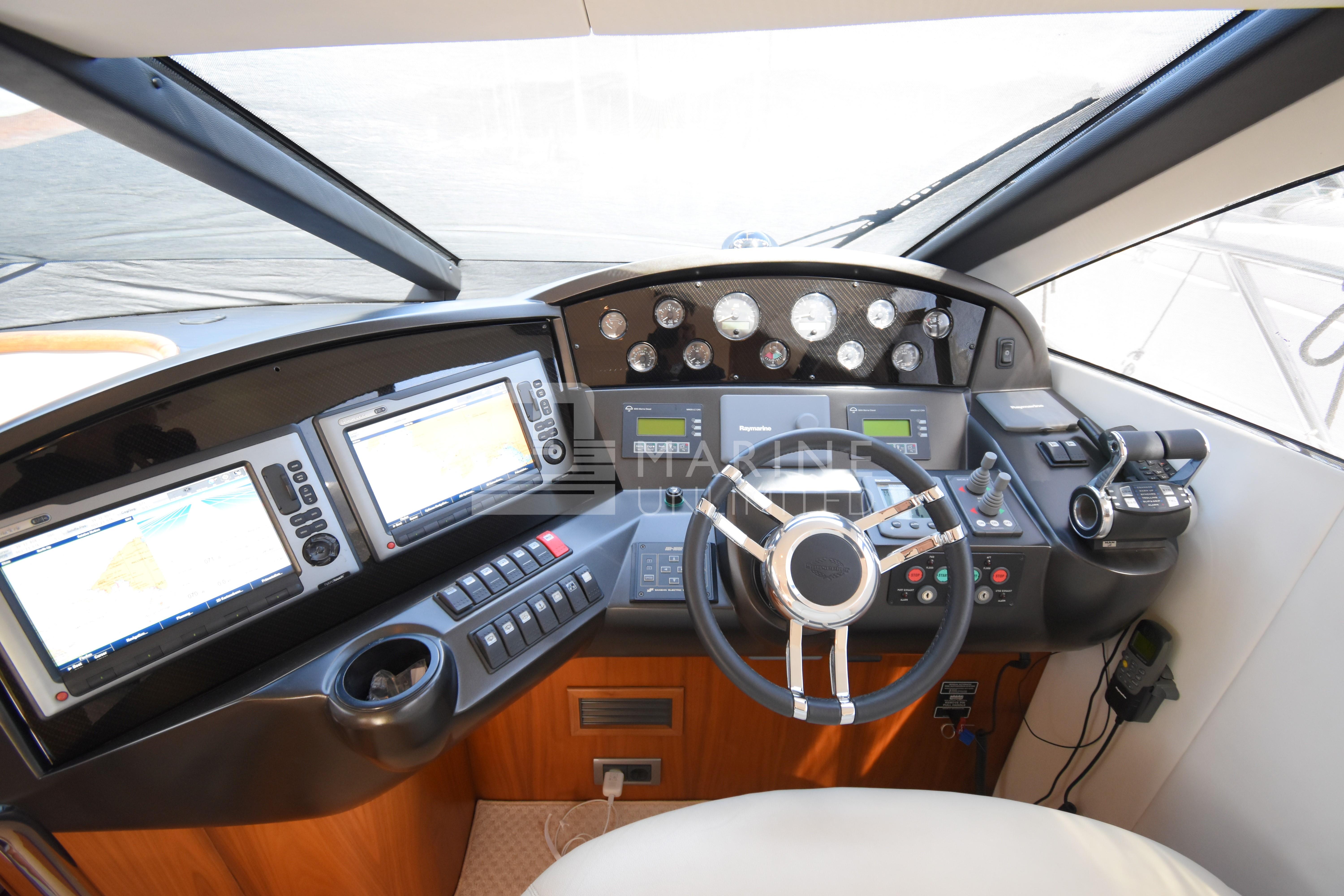 Cockpit of 2010 Sunseeker Manhattan 52 yacht with modern navigation equipment and steering wheel.