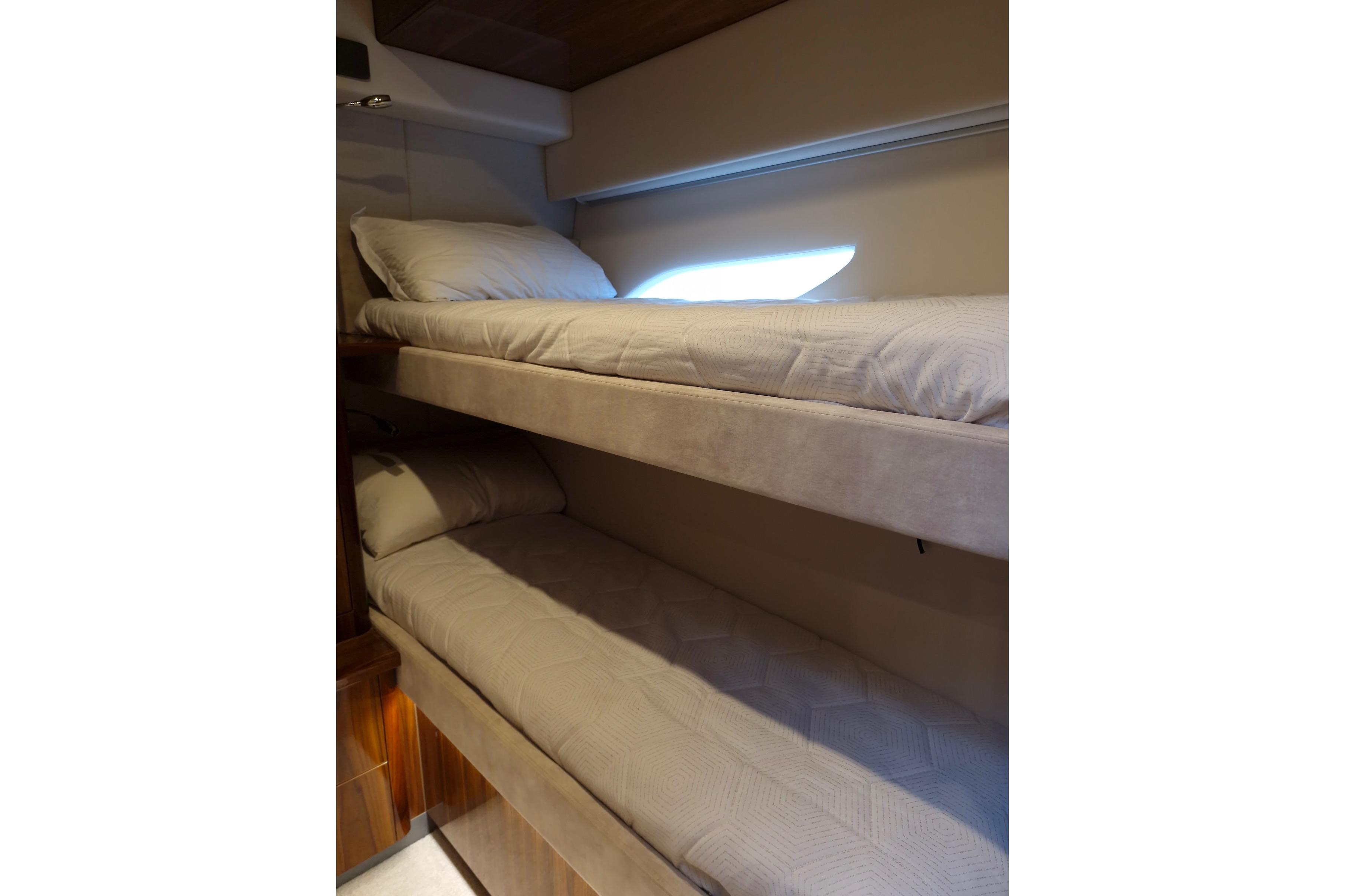 2020 Riviera 6000 Sport Yacht Platinum Edition interior with cozy bunk beds.