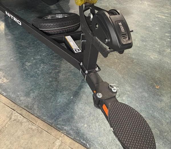 Trailer hitch of a 2025 Nitro Z18 boat on a textured floor.