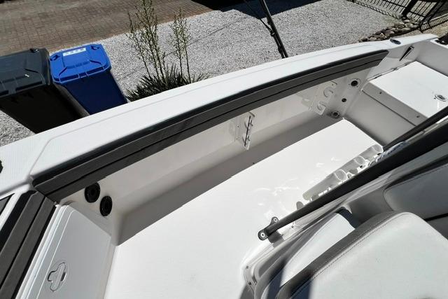2019 Yamaha Boats 190 FSH Sport interior, showcasing sleek white seating and storage area.