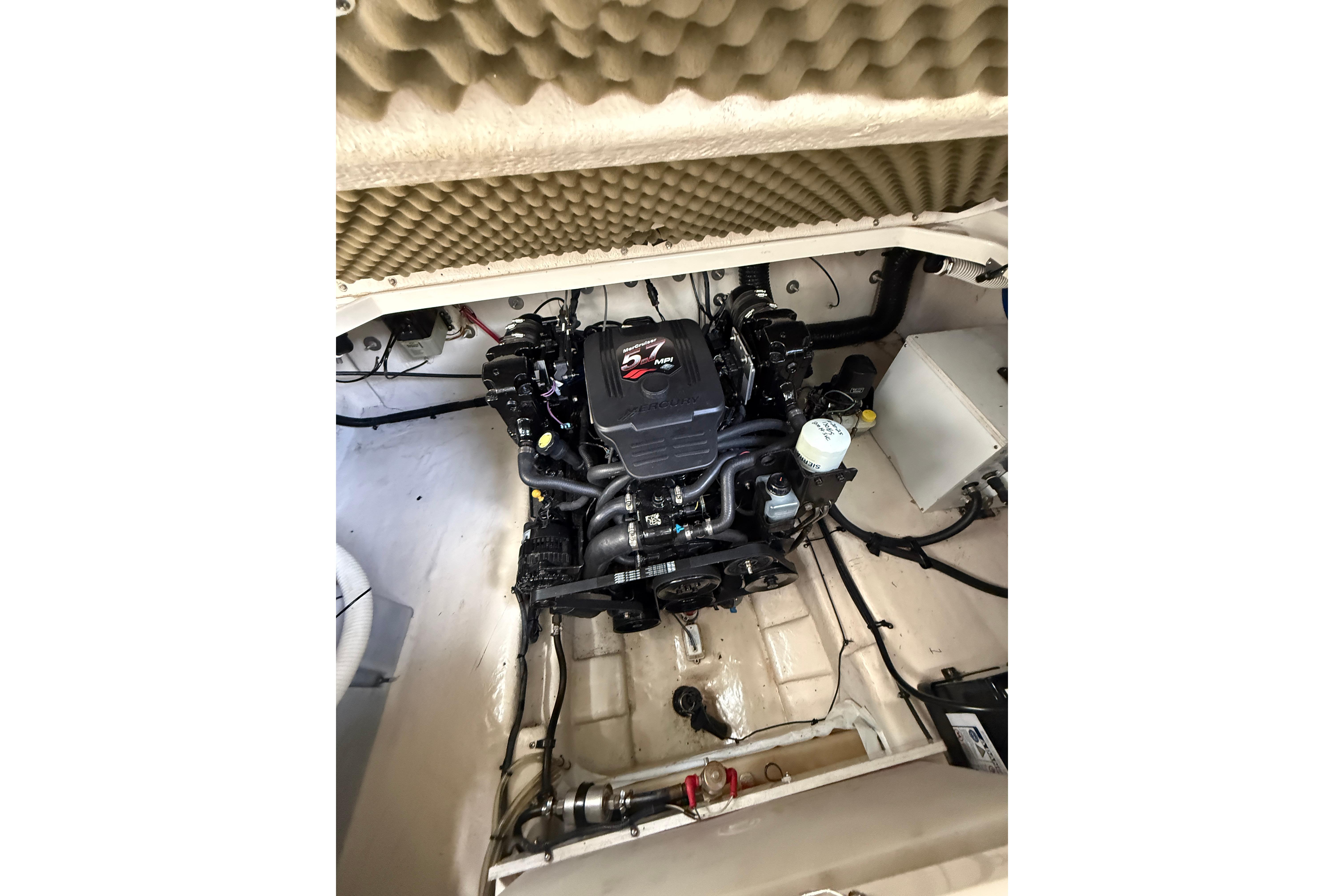 Engine compartment of a 2004 Sea Ray 240 Sundancer boat, showcasing the motor and components.