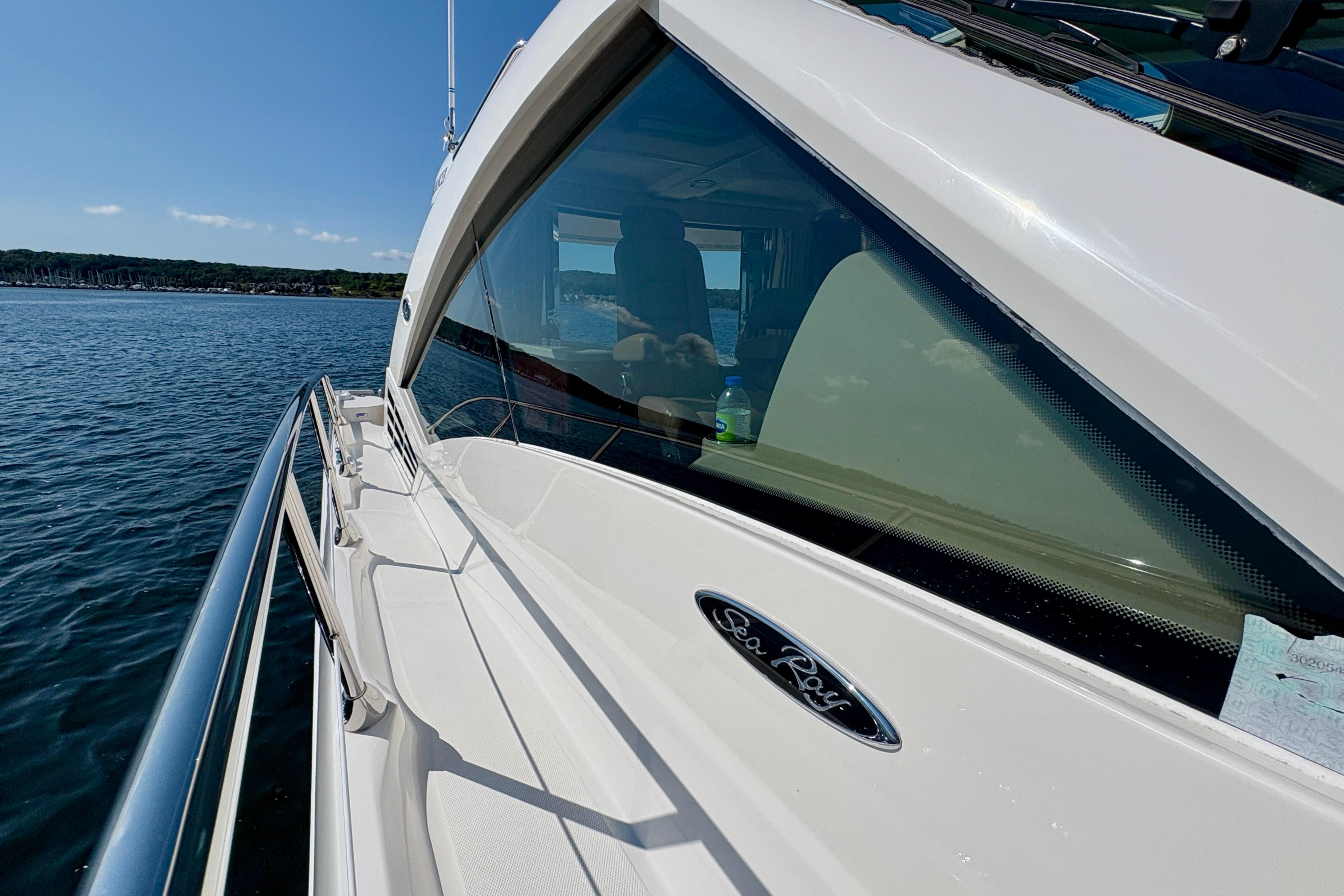 2008 Sea Ray 60 Sundancer yacht on calm water, side view with logo.