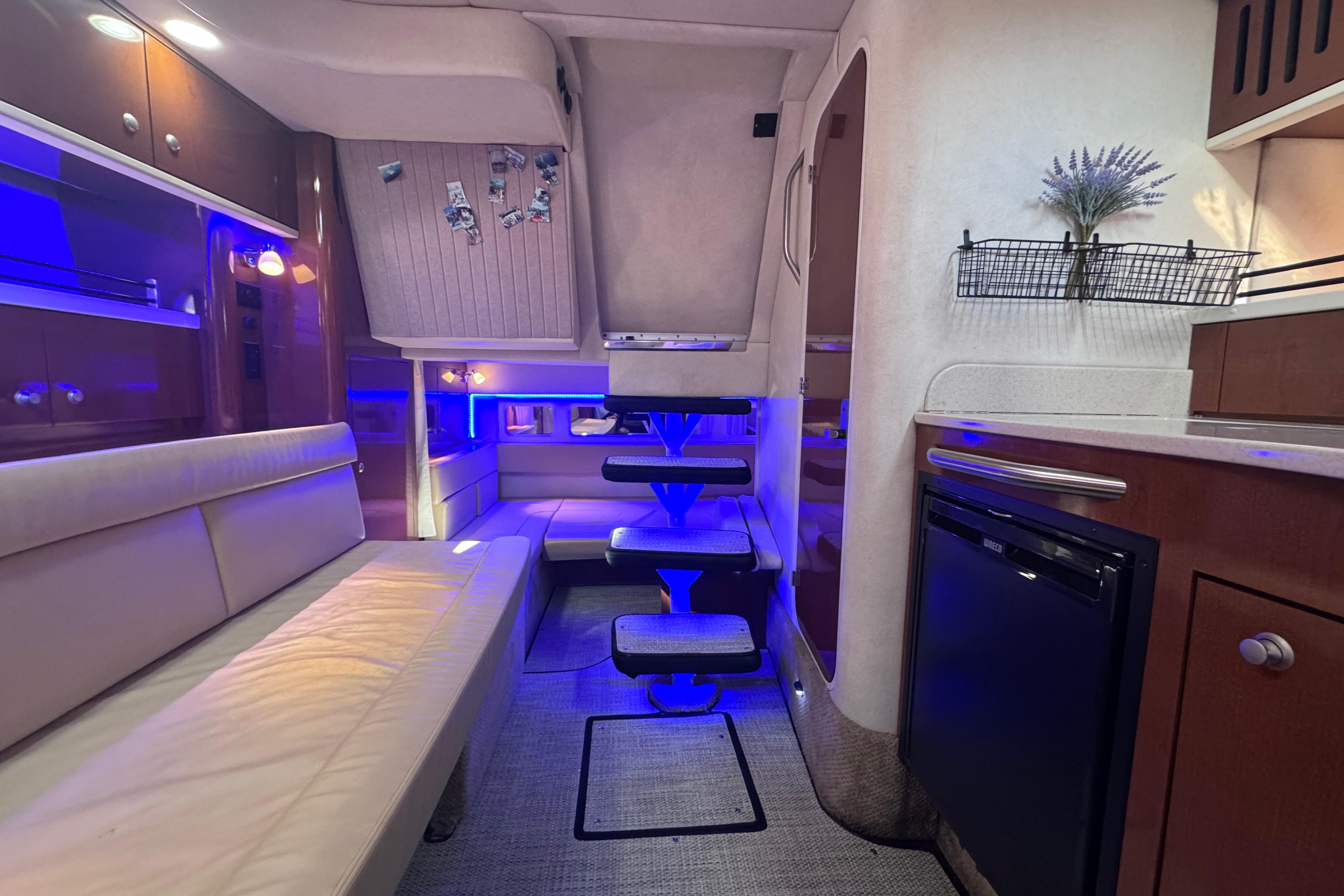 Interior of 2008 Sea Ray 350 Sundancer yacht with modern lighting and cozy seating.