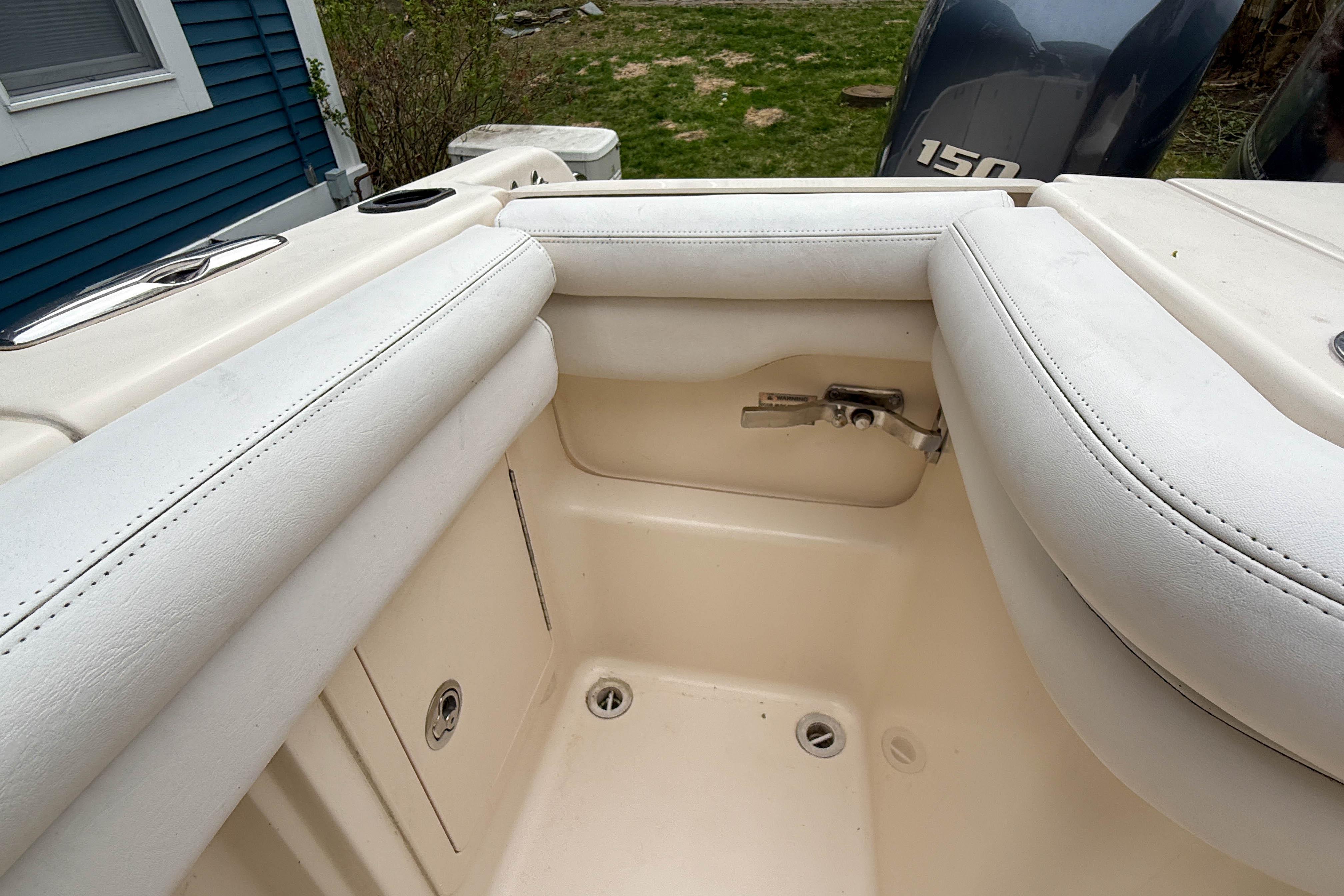 Interior view of a 2015 Grady-White Freedom 275 boat with cushioned seating.