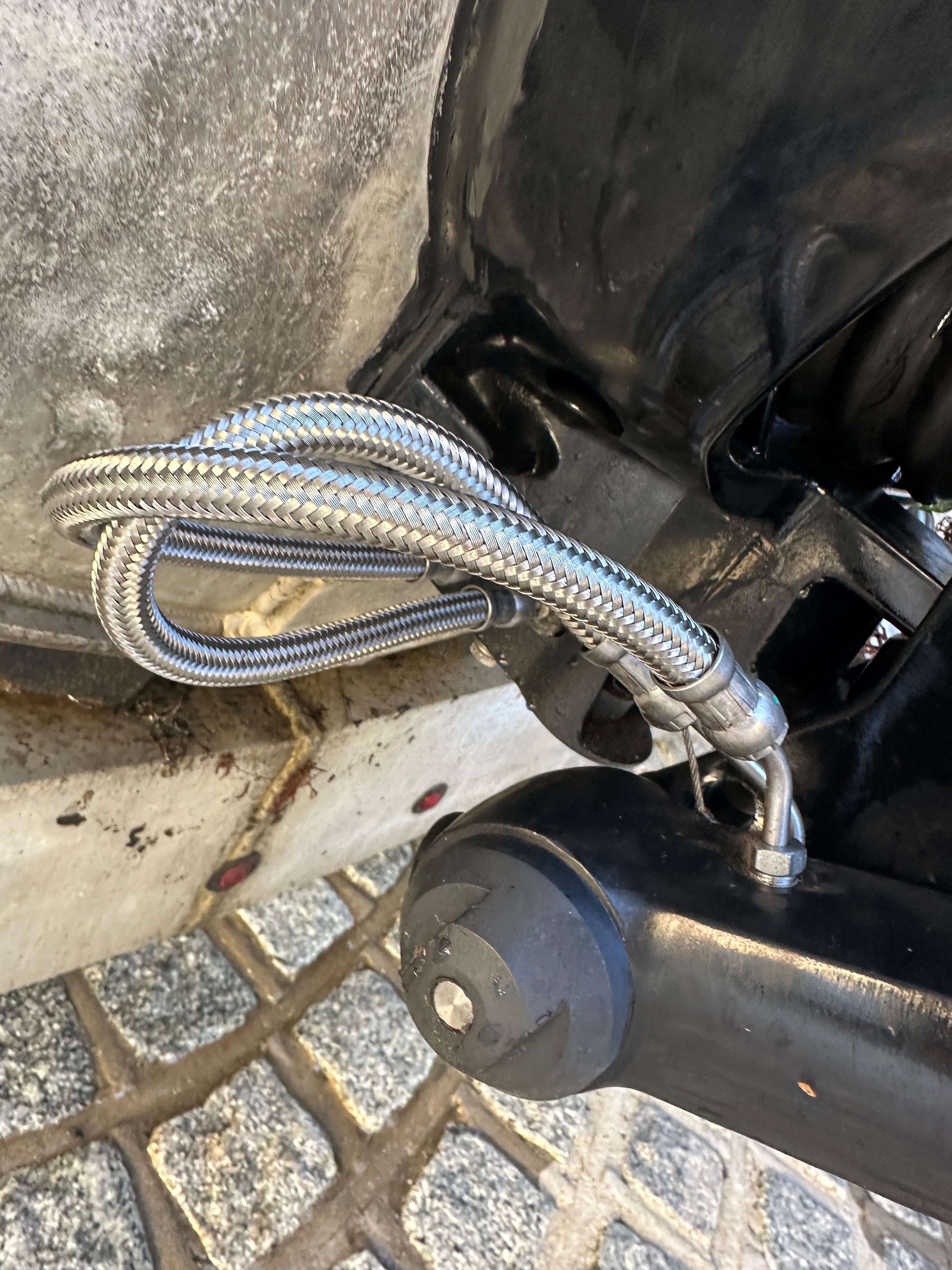Close-up of Zodiac 24 (2008) engine part with braided metal hose.
