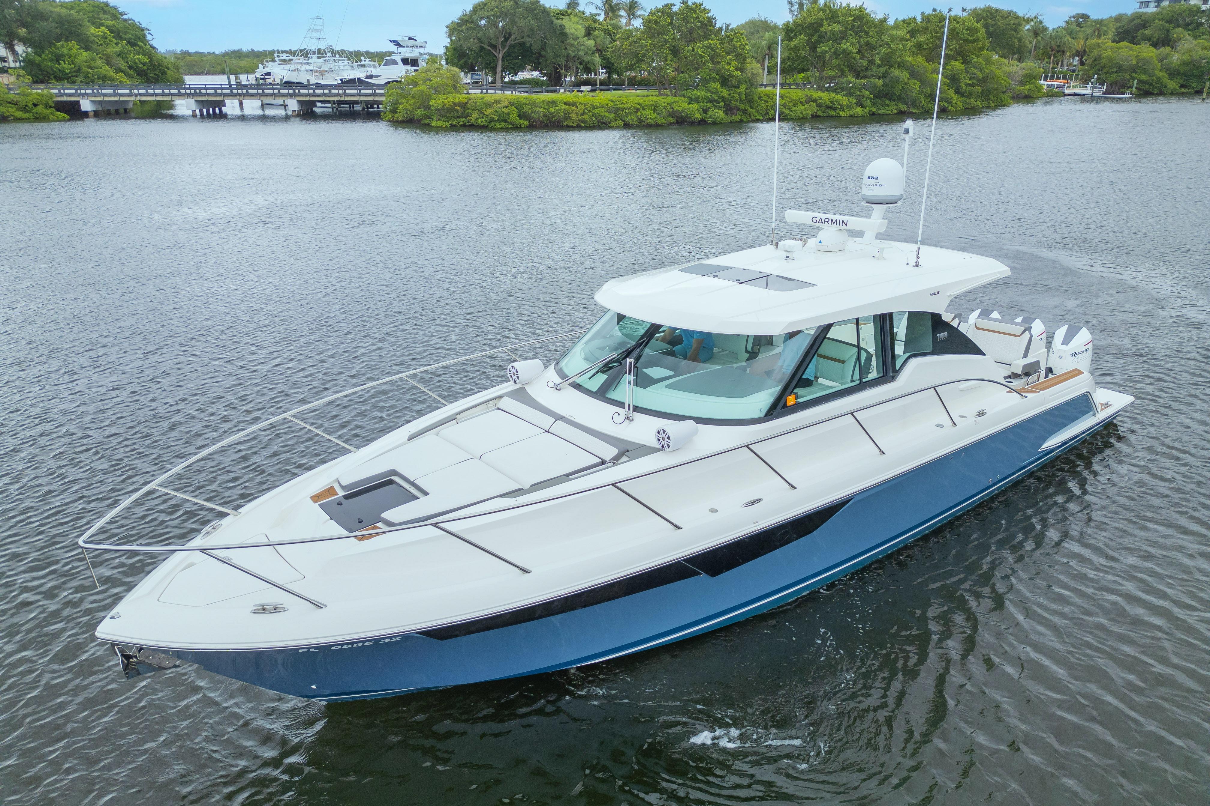 2021 Tiara Sport 43 LE yacht cruising on a serene waterway.