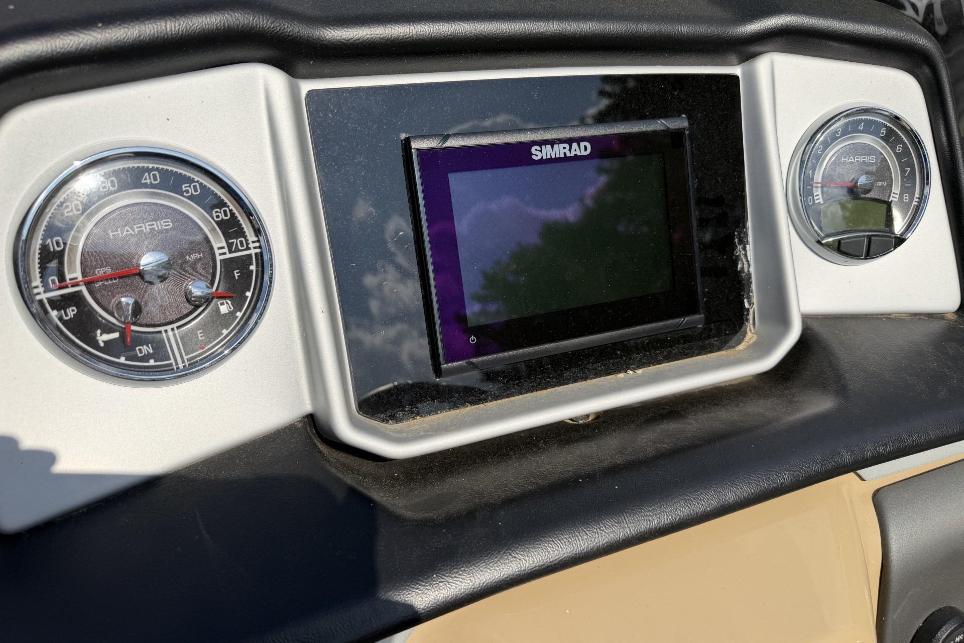 Dashboard of 2022 Harris Solstice 230 CWDH with Simrad display and gauges.