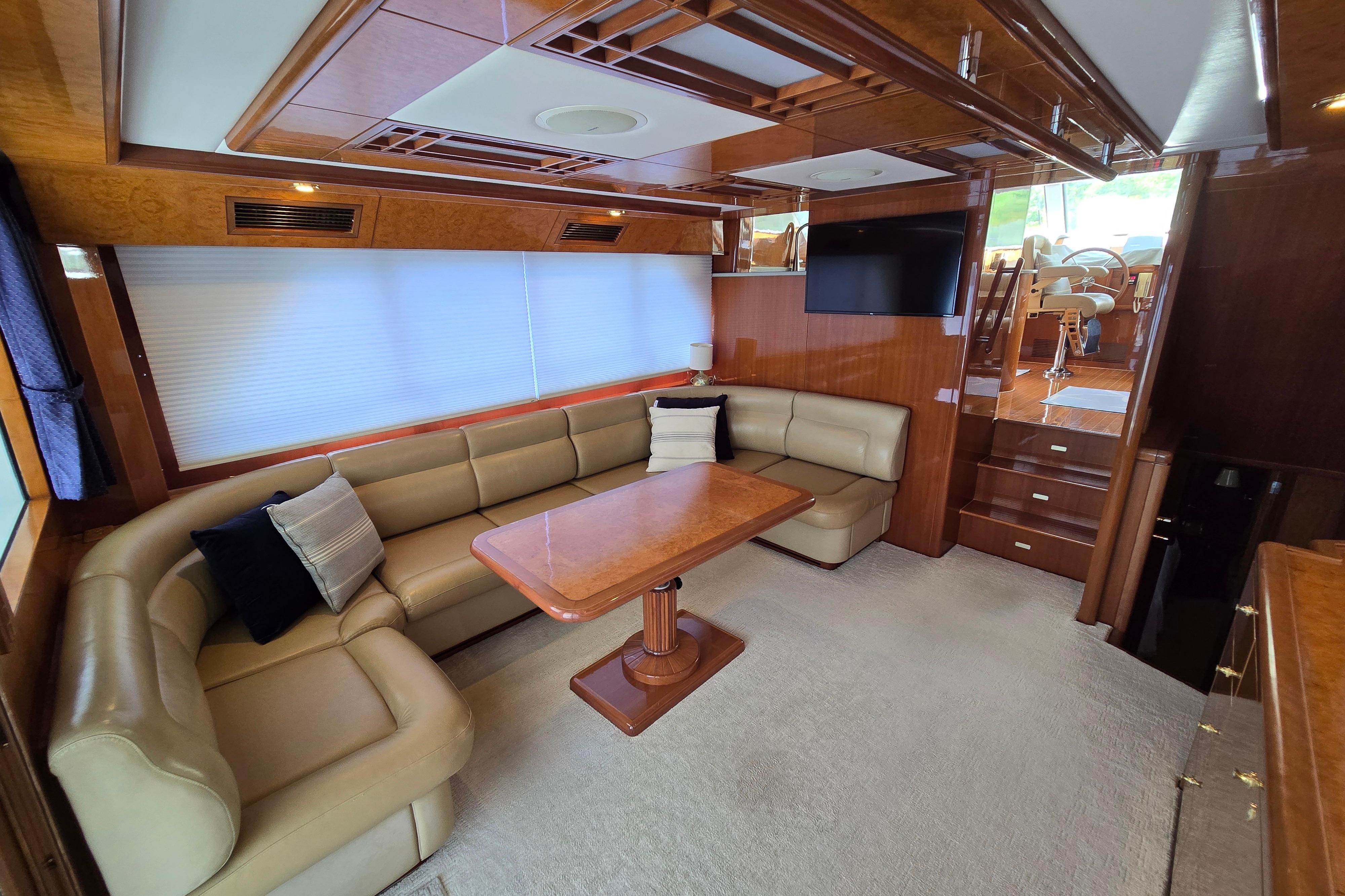 Luxurious 2004 Grand Harbour 58 yacht interior with plush seating and elegant wood finishes.